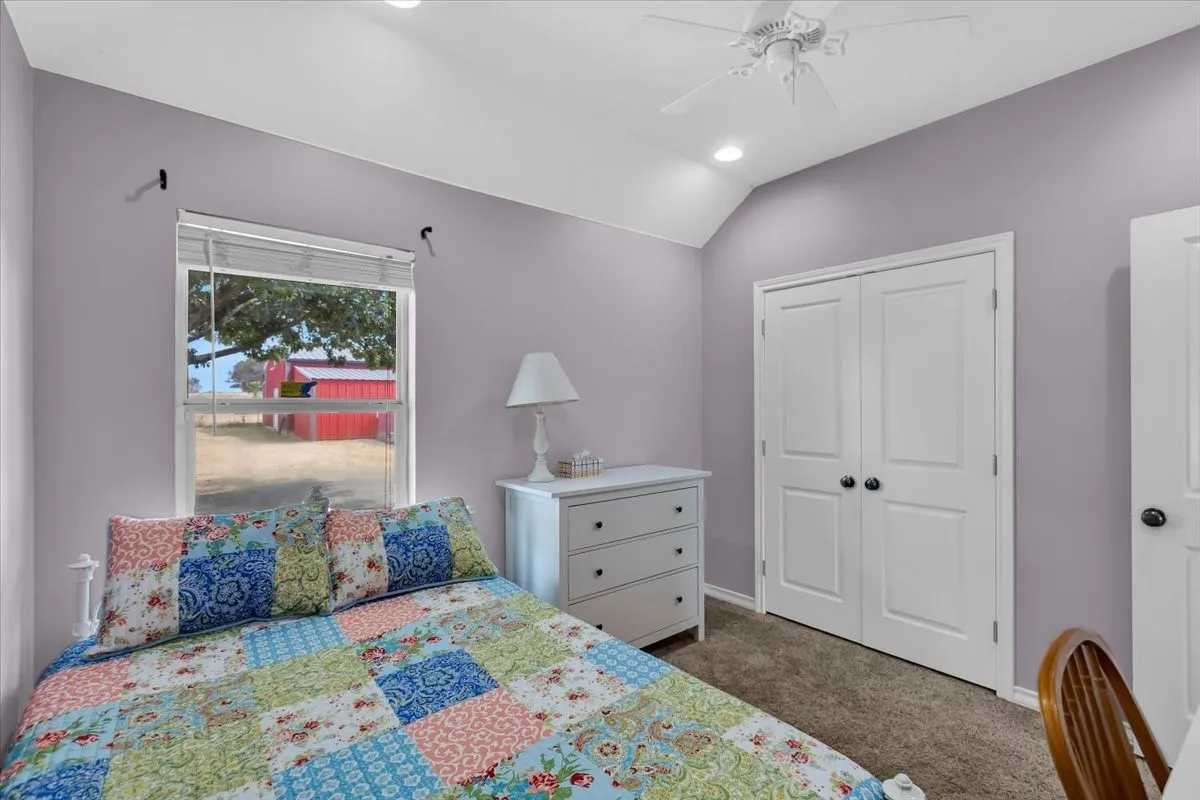 Vaulted ceiling with recessed lighting and a ceiling fan