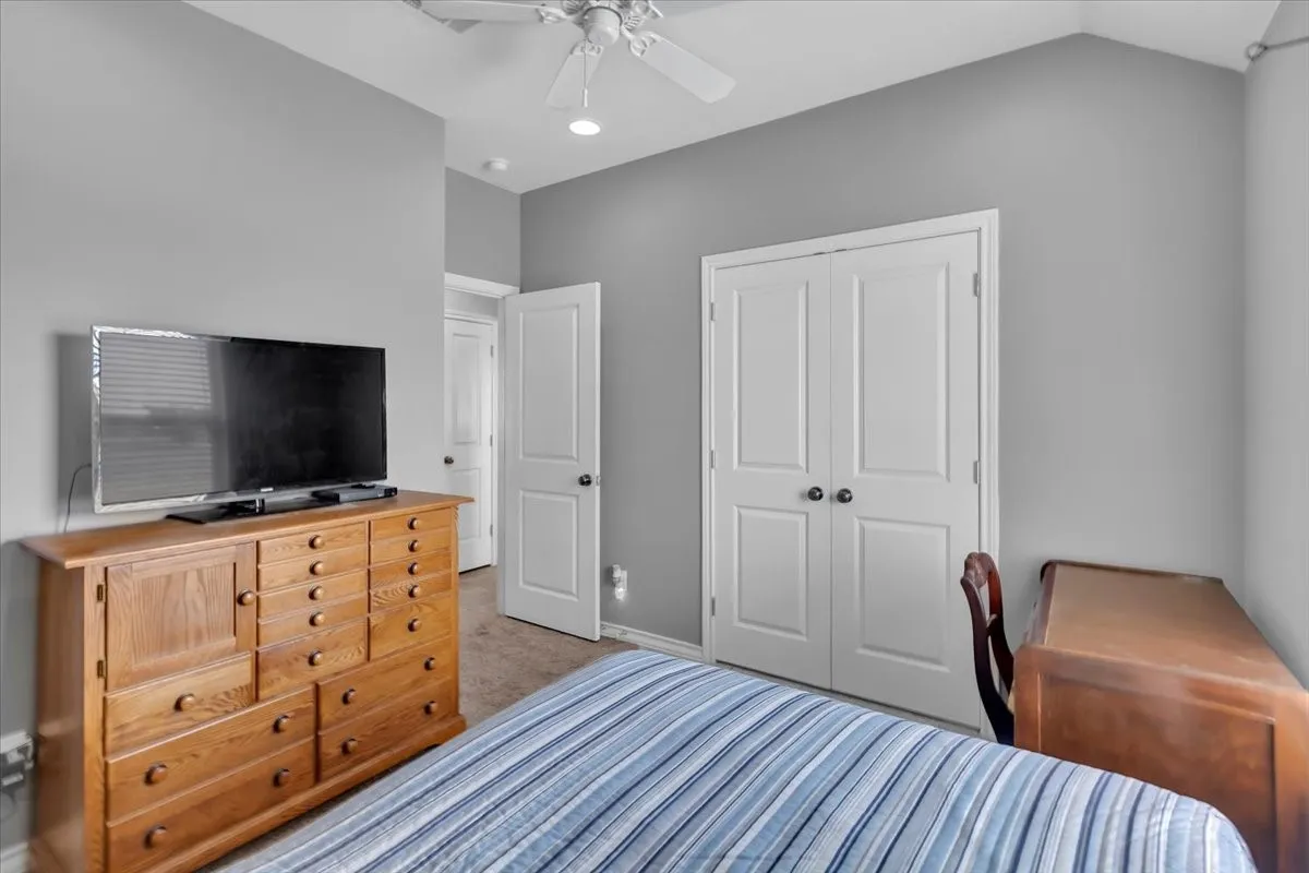 Vaulted ceiling with a ceiling fan, recessed lighting, and a white paneled bi-fold door