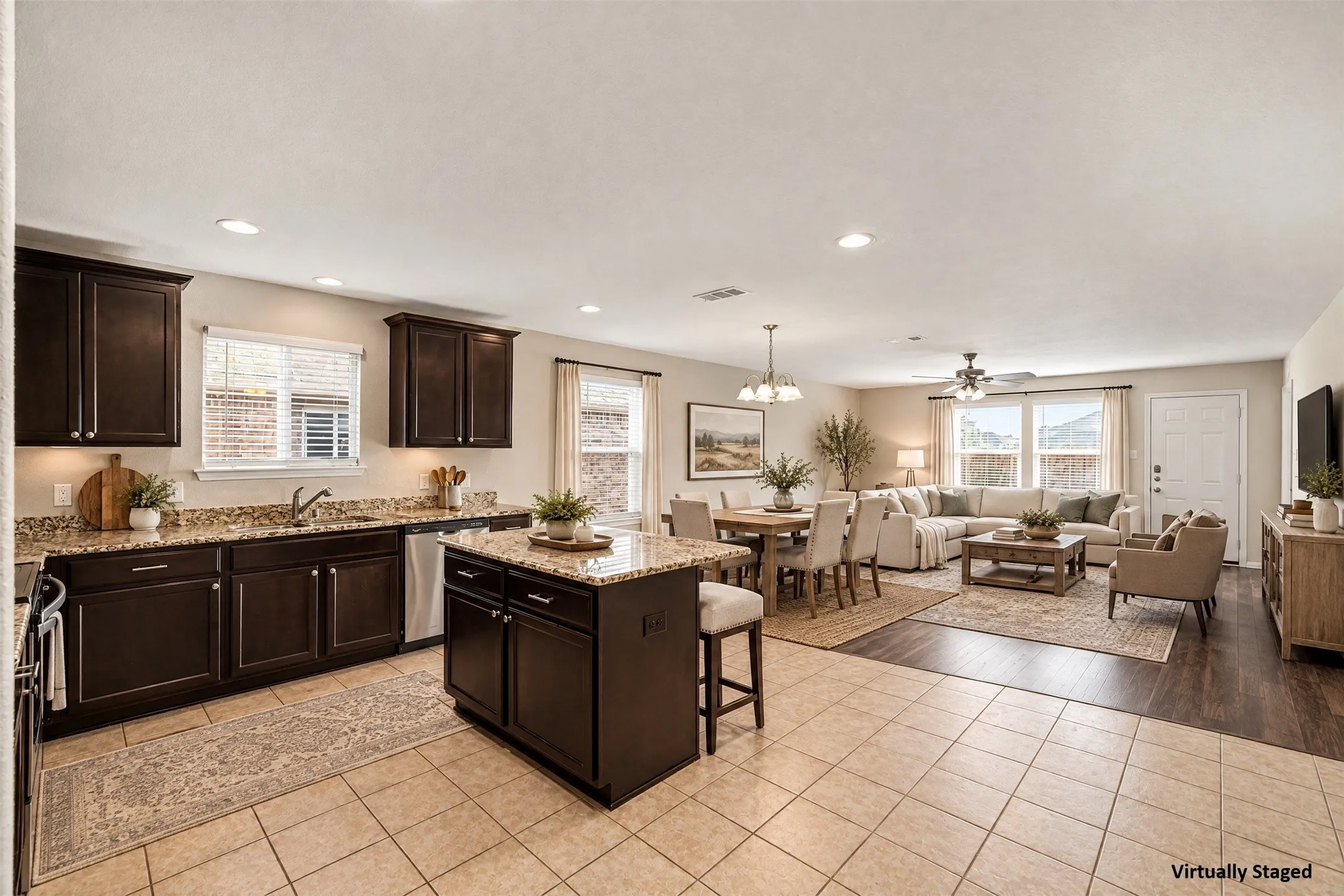 Virtually Staged View of kitchen into the dining and family room. Open floorplan