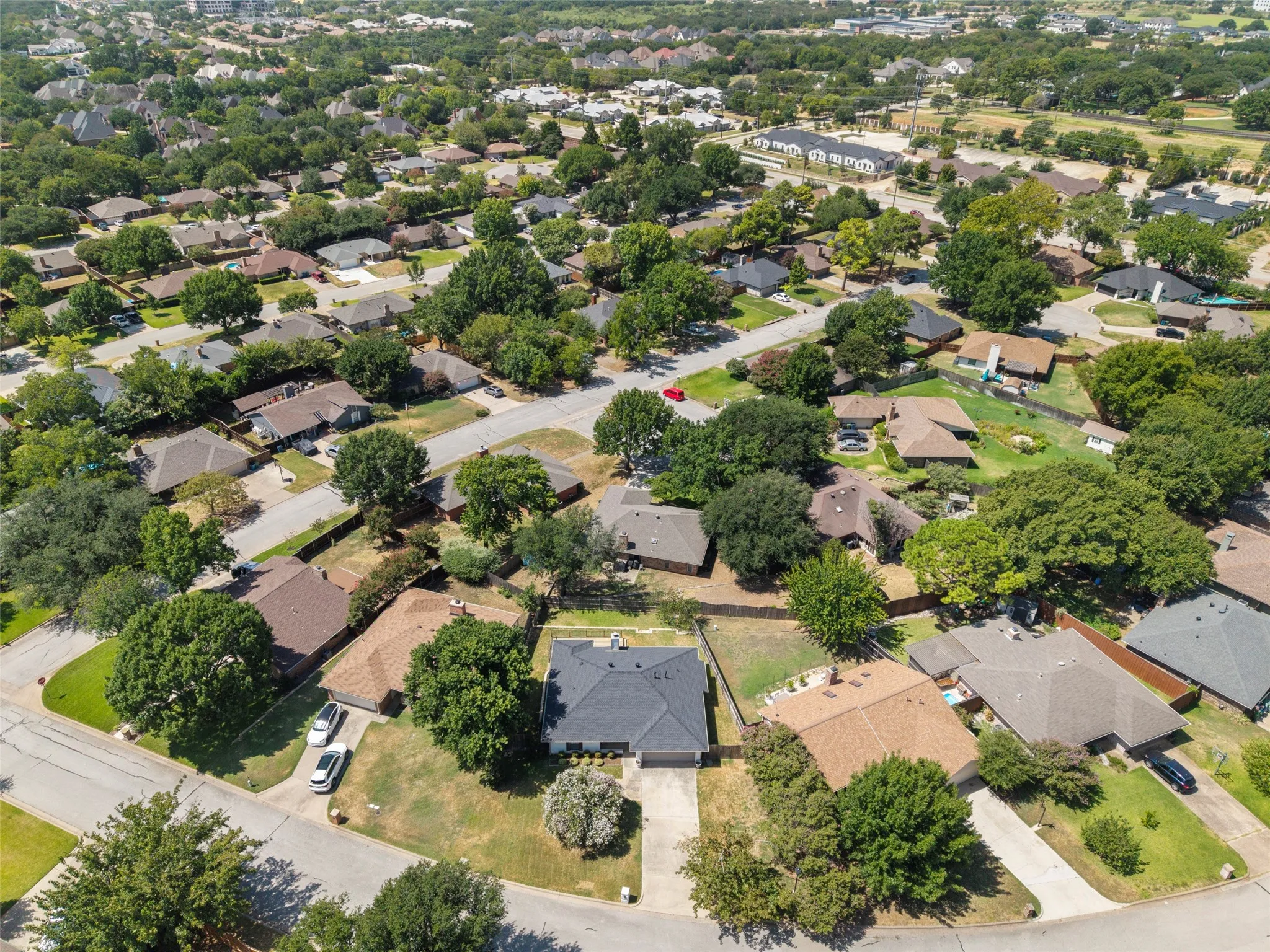 Residential neighborhood with mature trees, established streets, and single-family residences