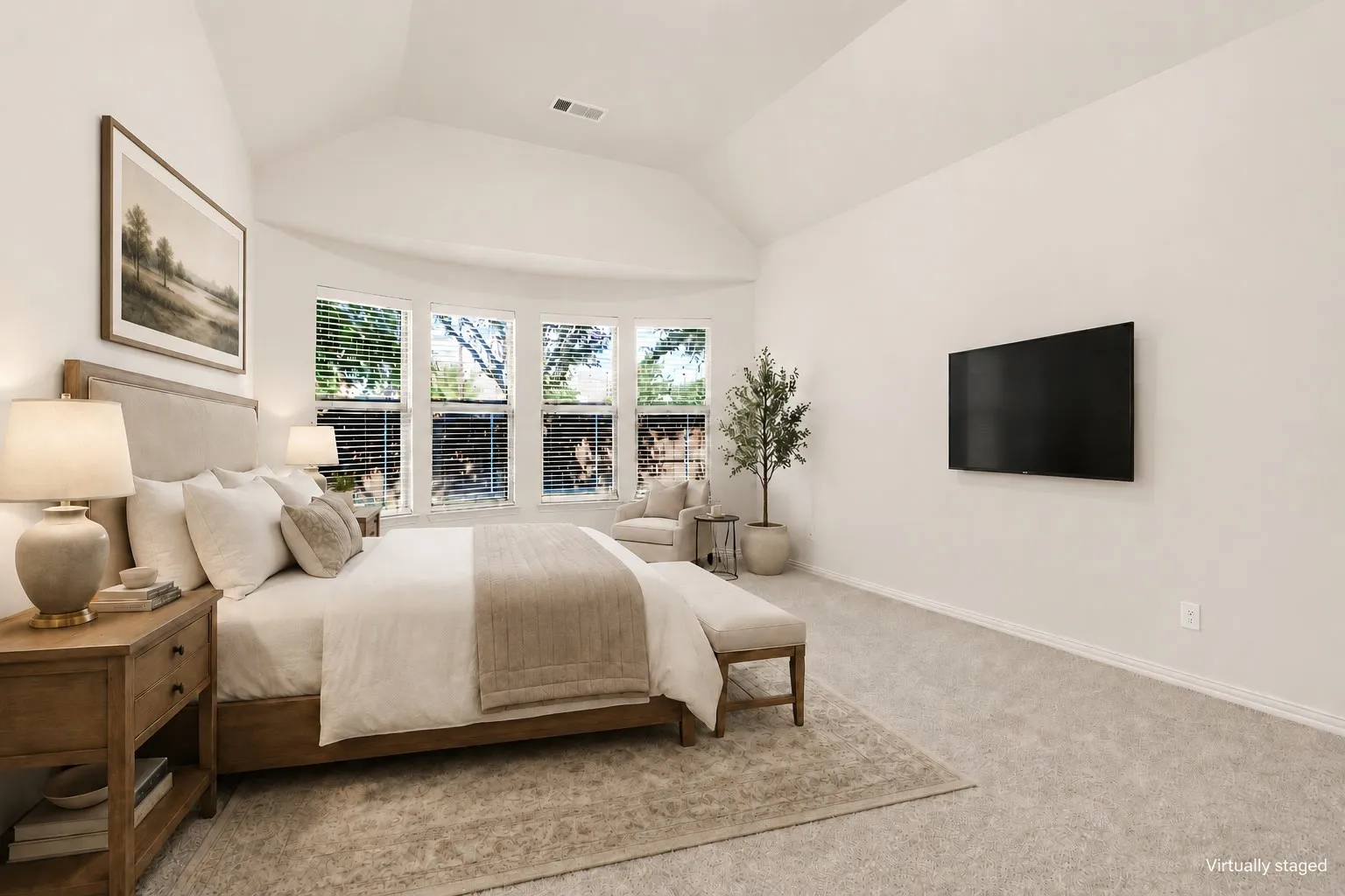 Vaulted ceiling, multiple windows, carpet flooring, and light-toned wall paint