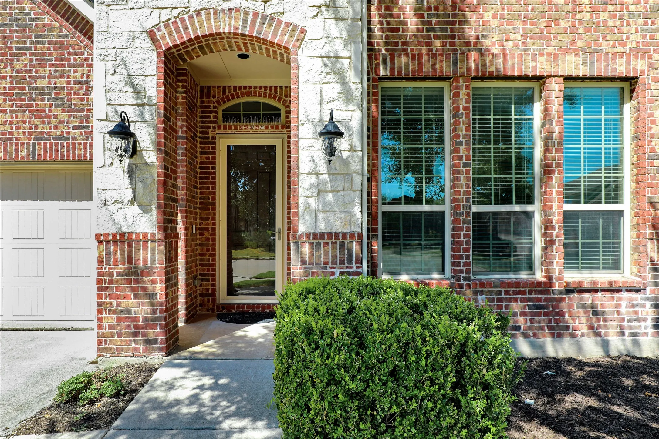 Brick and stone exterior with an arched entryway