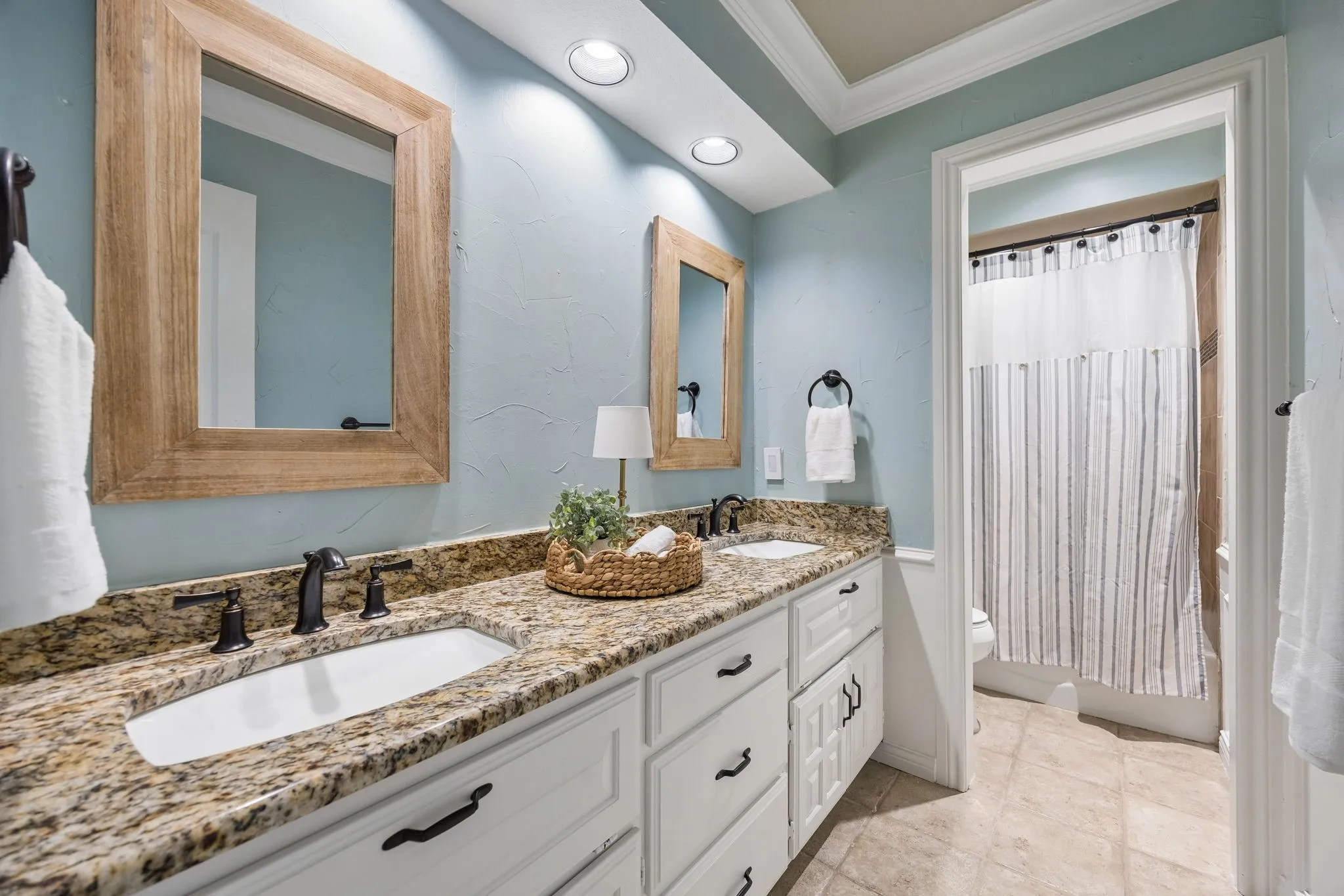 Downstairs bath with dual vanity with granite countertops