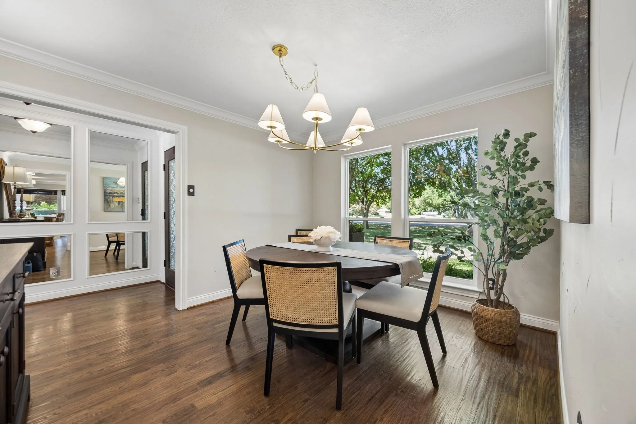 Dining room with large window overlooking the lush front yard