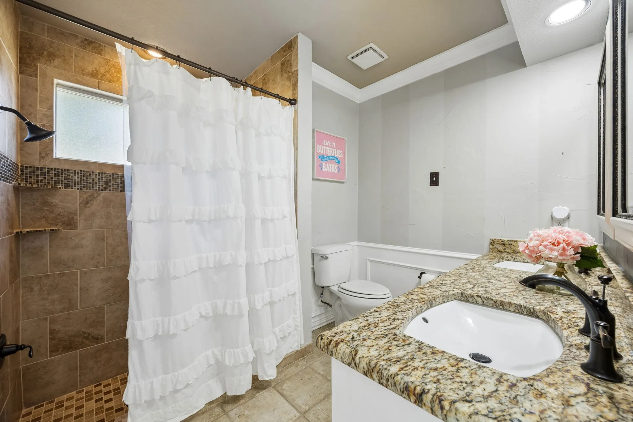 Second primary ensuite bath with large shower and dual sink vanity.