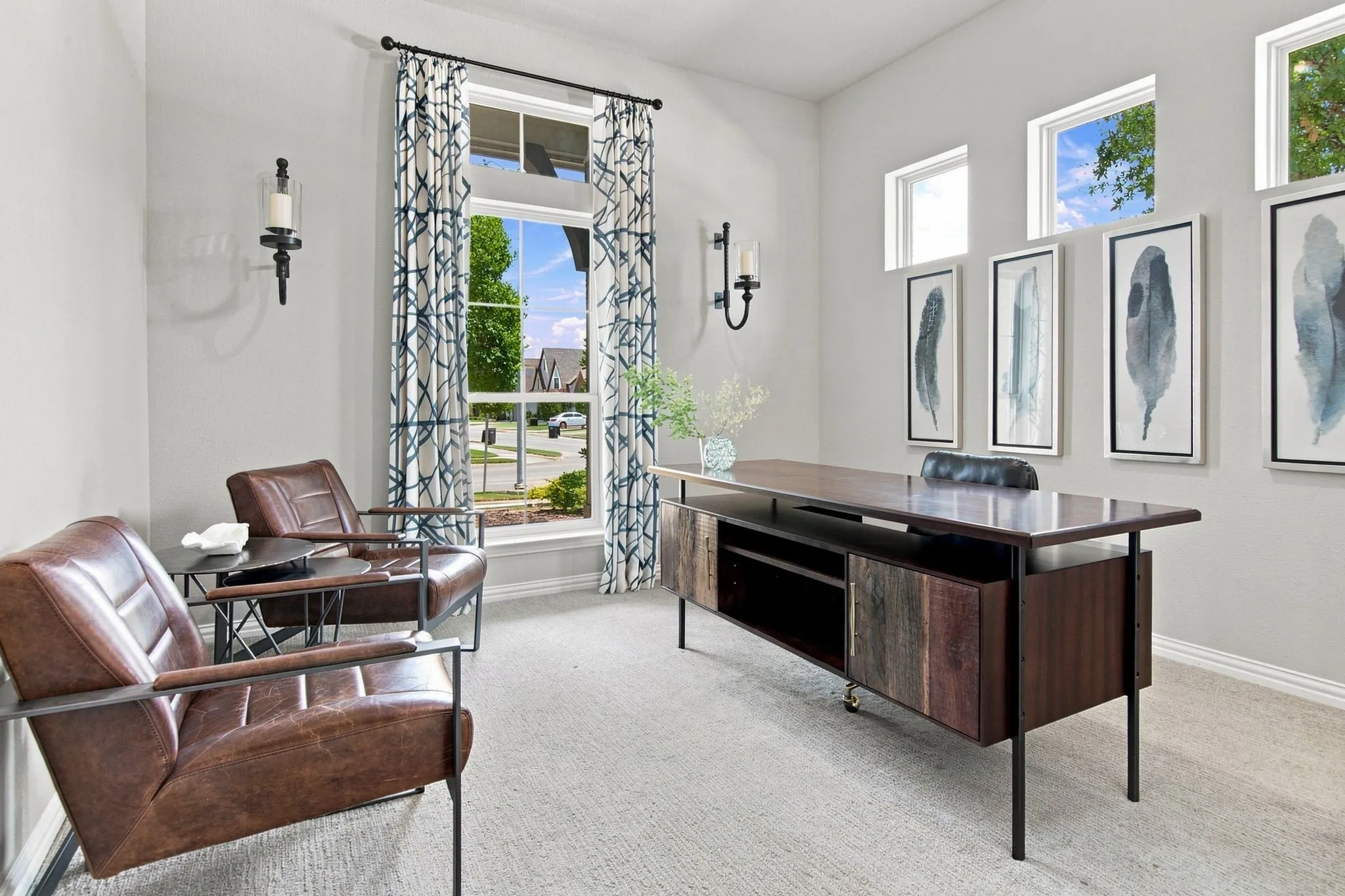 Vaulted ceiling, two wall sconces, large window with transom, three upper windows, and light-toned carpeting