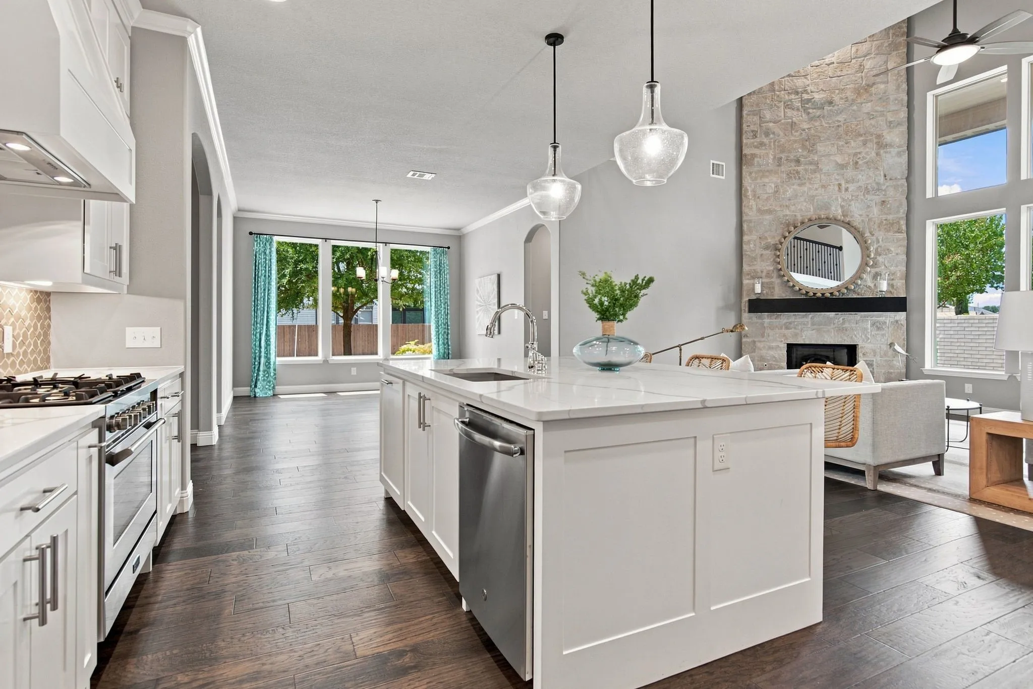 Gourmet kitchen with a large island, stainless steel appliances, and a tile backsplash