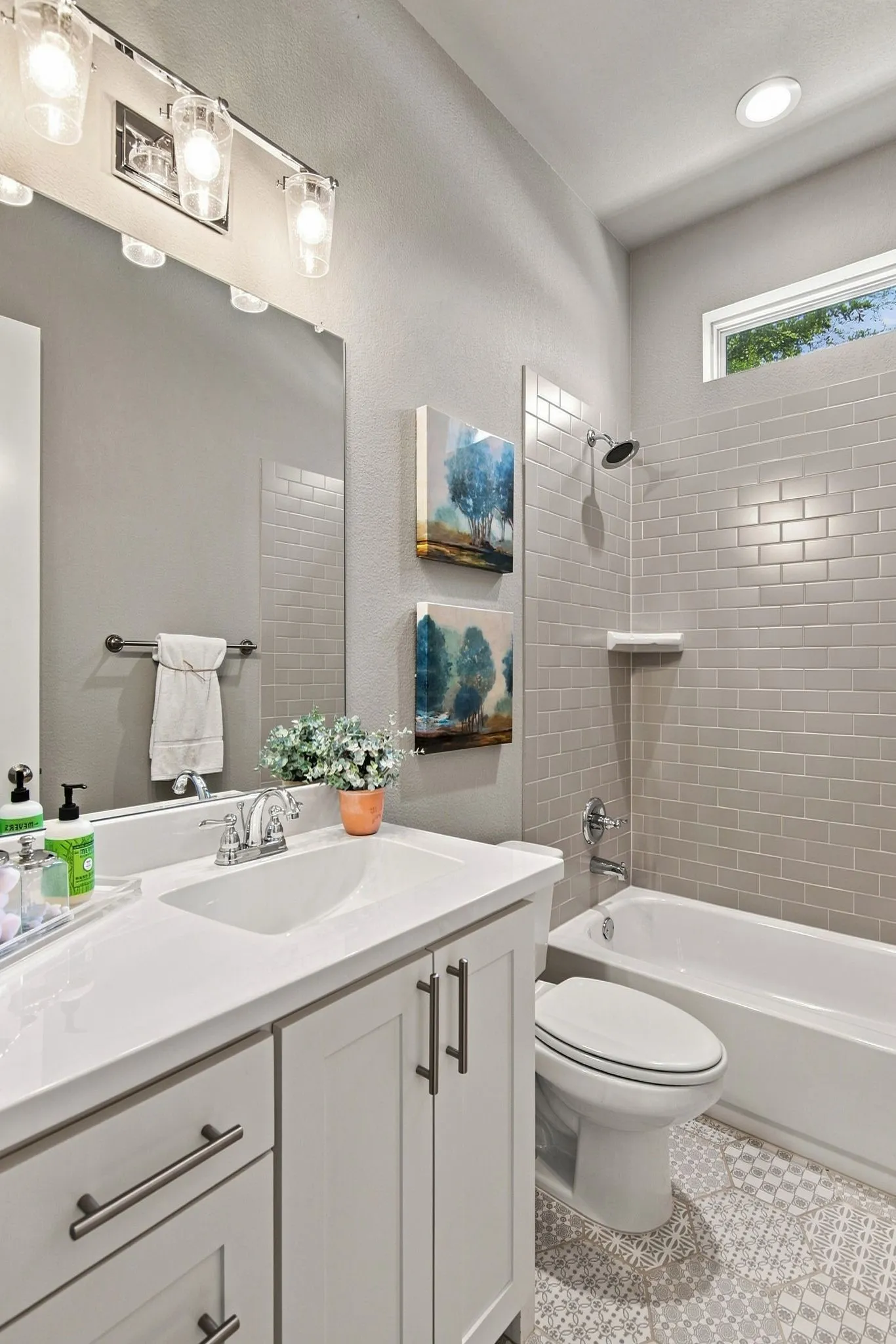 Vanity with white countertop, chrome faucet, and integrated sink