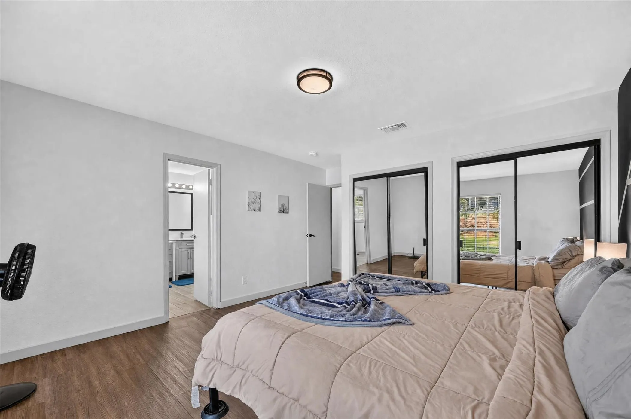 Wood-finish flooring with white walls and a contrasting accent wall