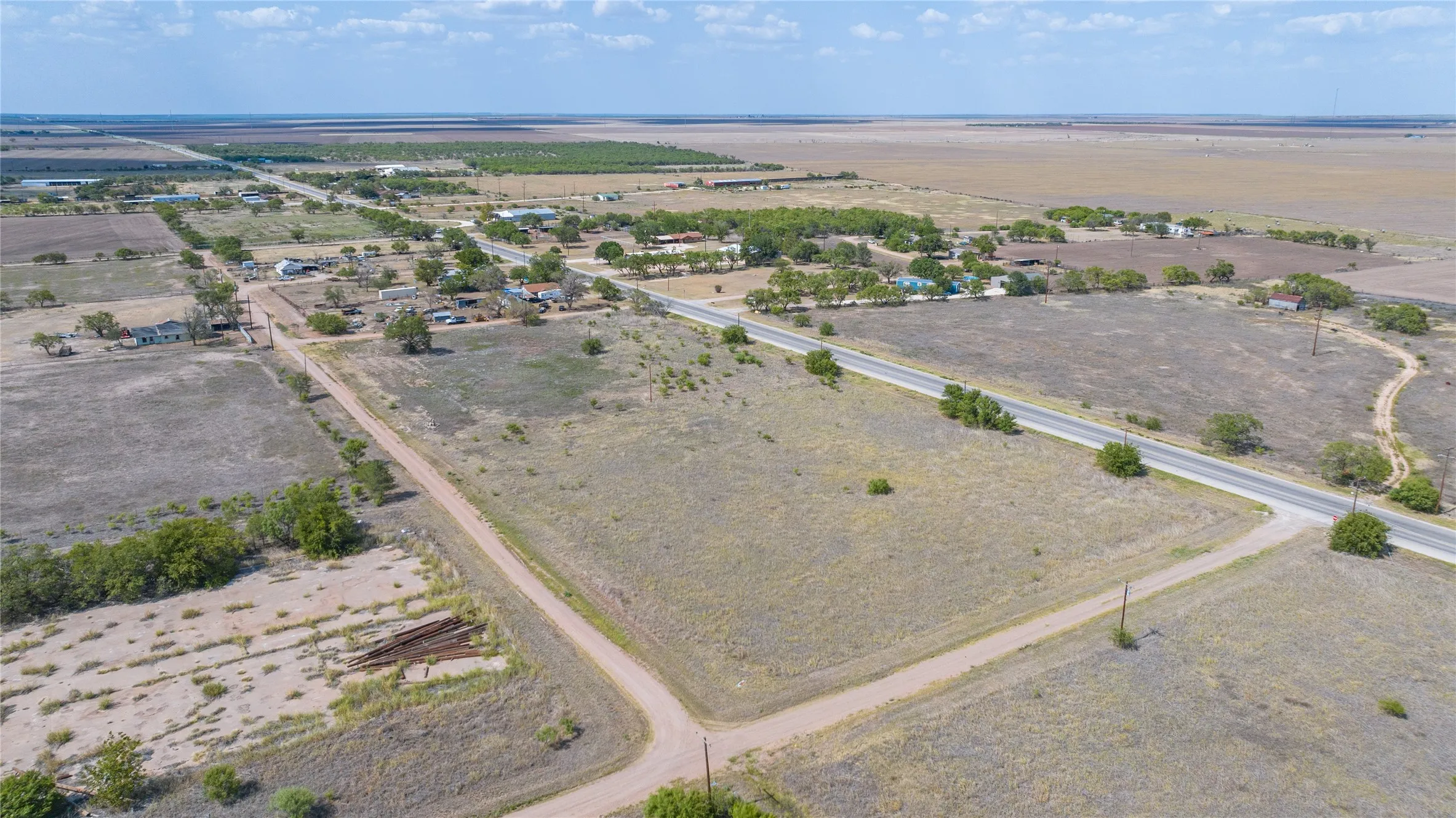 Expansive land parcel with direct paved road access and unpaved road frontage