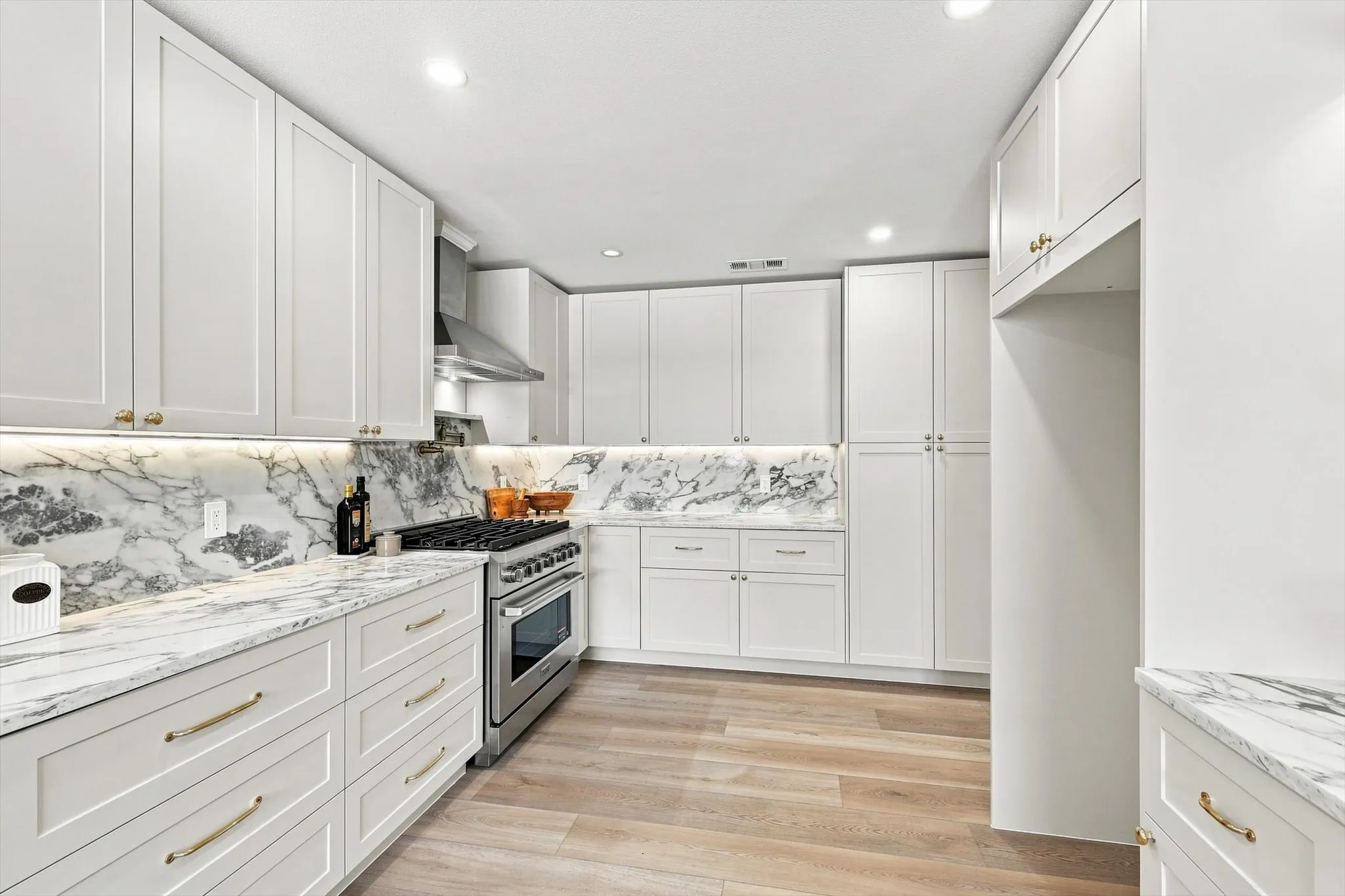 An abundance of cabinets and storage space. Large pantry, quartz countertops, luxury vinyl plank flooring and updated can lighting