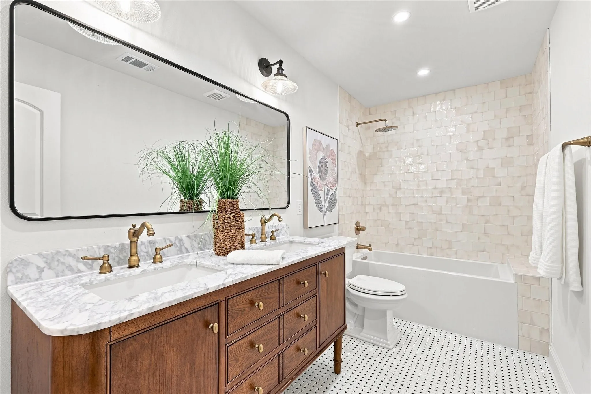 Custom secondary bathroom with dual sinks, custom cabintry, tiled shower-tub. Plenty of cabinet space for extra towls and linen space.
