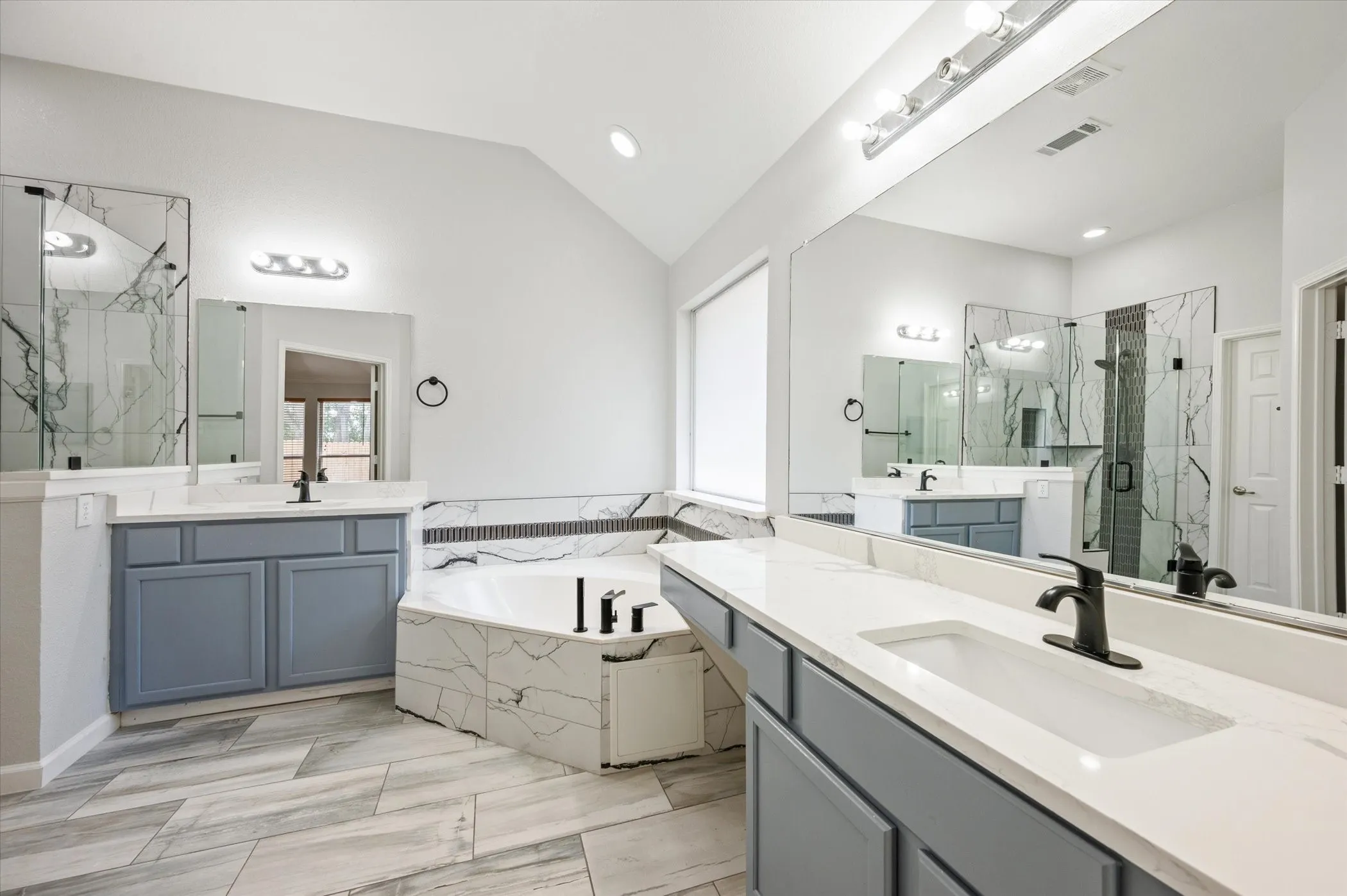 Dual vanities with quartz countertops, integrated sinks, and matte black fixtures