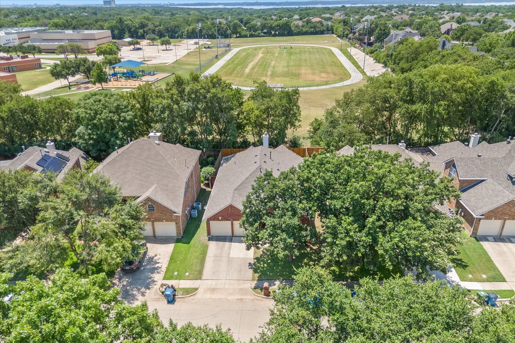 Brick exterior, two-car garage, established landscaping, asphalt shingle roofing, and concrete driveway
