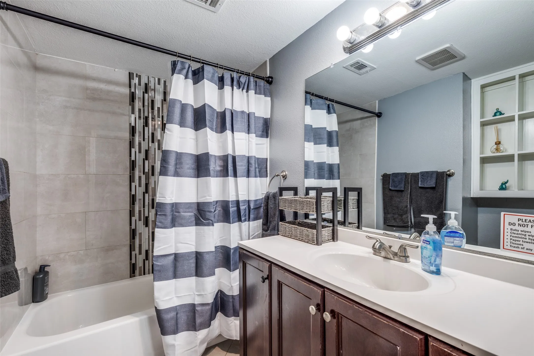 Hall bath with shower/ tub combo and large vanity