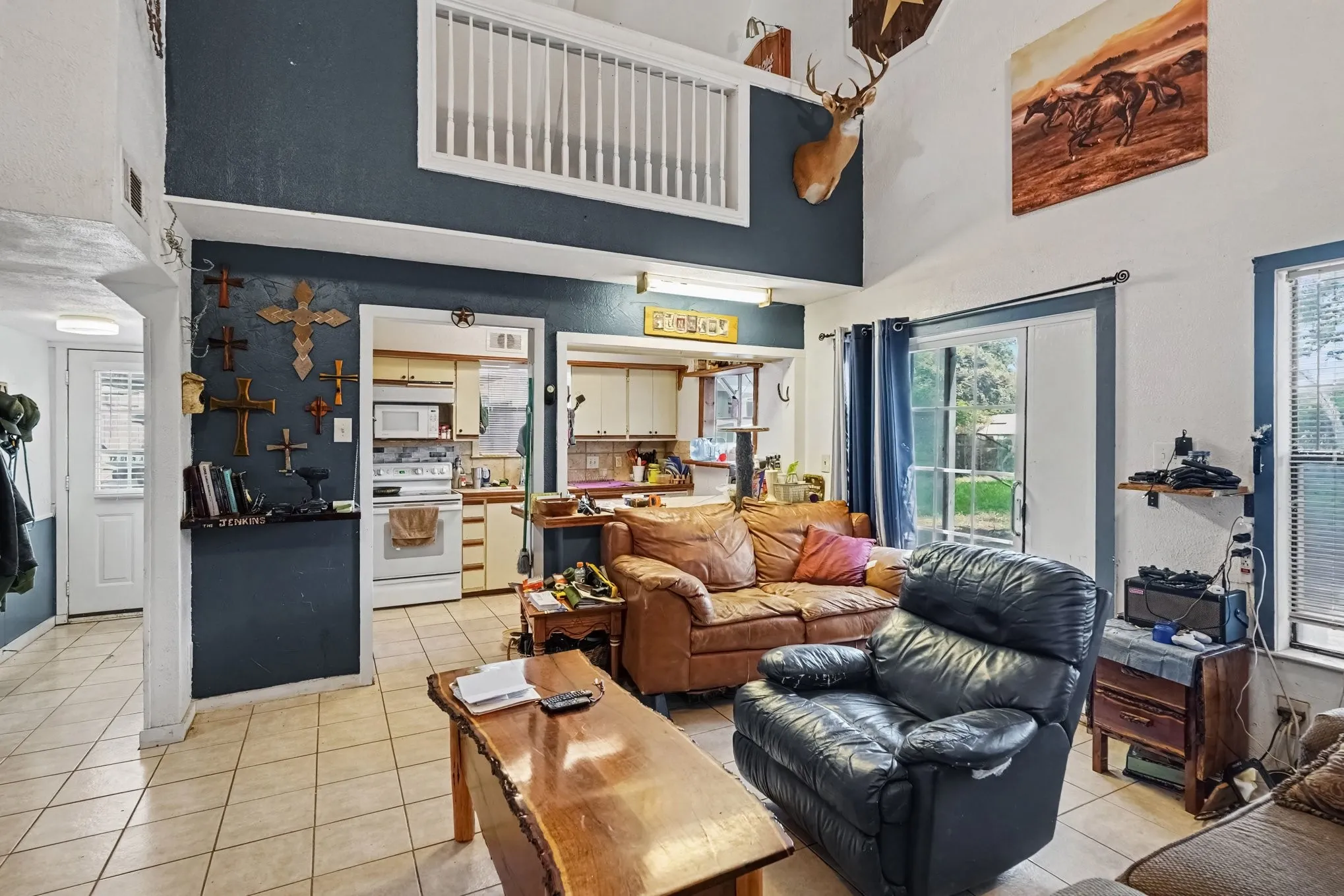 Grand living room perspective displaying double-height ceilings, overhead ceiling fan, and open-concept flow.