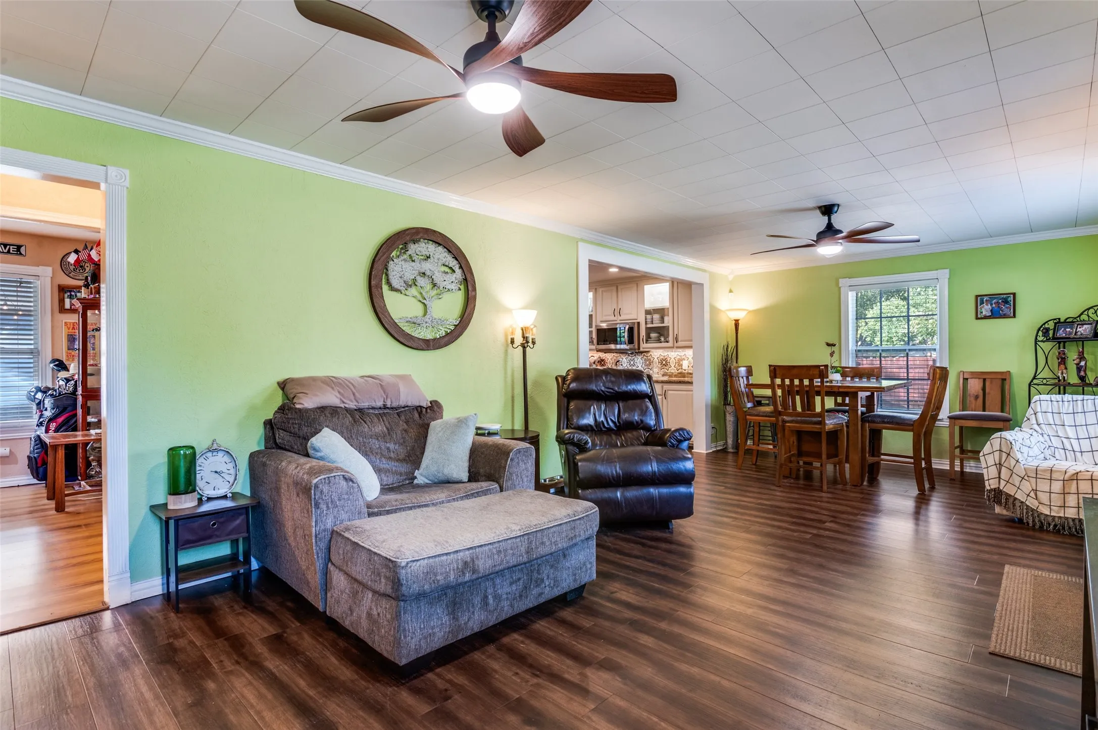 Wood-finish flooring, ceiling fans, and a dining area