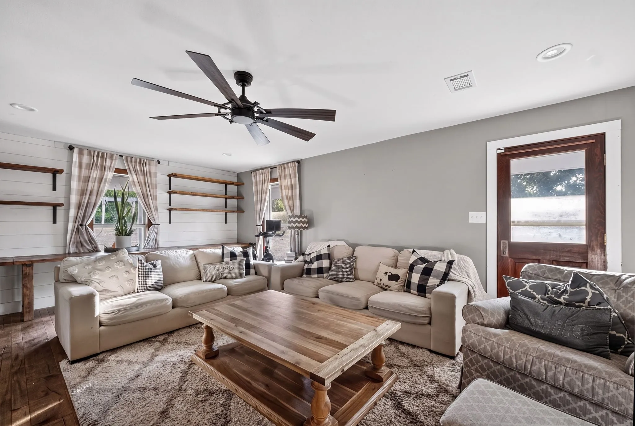 Recessed lighting, wood-finish flooring, and a ceiling fan with integrated lighting