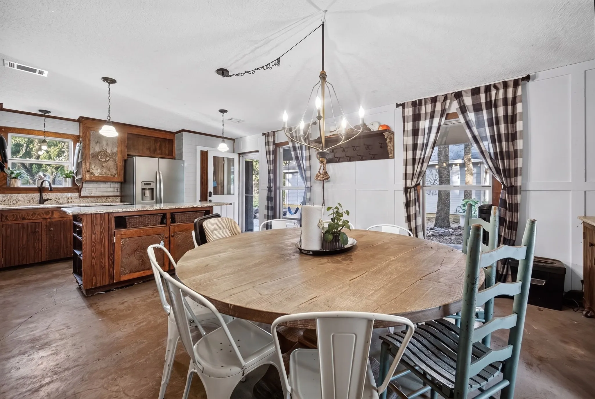 Kitchen and dining area featuring wood cabinetry and a kitchen island.