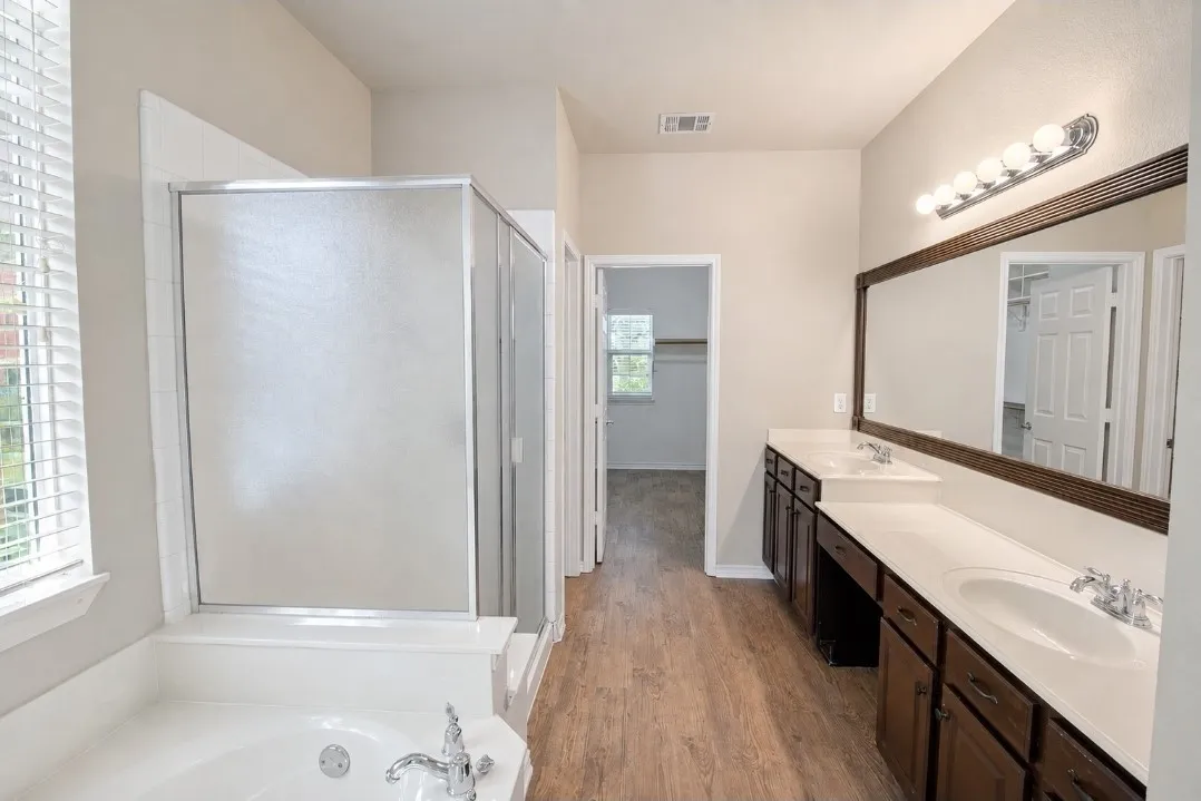 Dual vanity with integrated sinks, framed mirror, and chrome fixtures