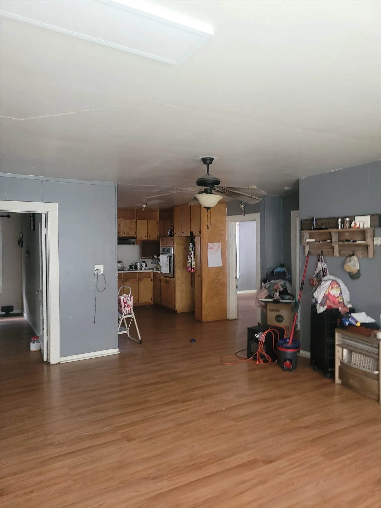 Open concept living area featuring wood-finish flooring, a ceiling fan, and recessed lighting