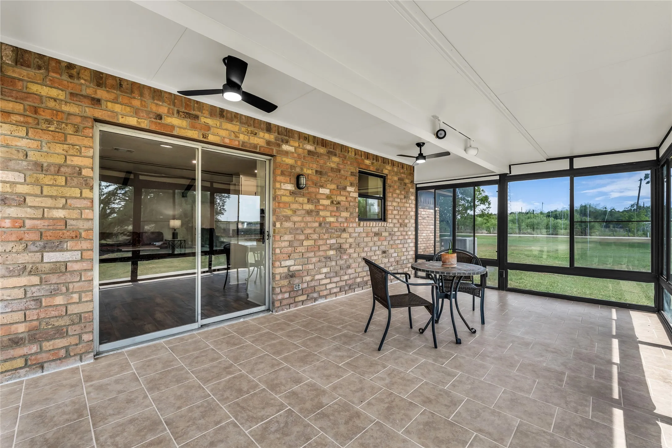 Screened porch completely closes off to become a 4 seasons room for year-round use.