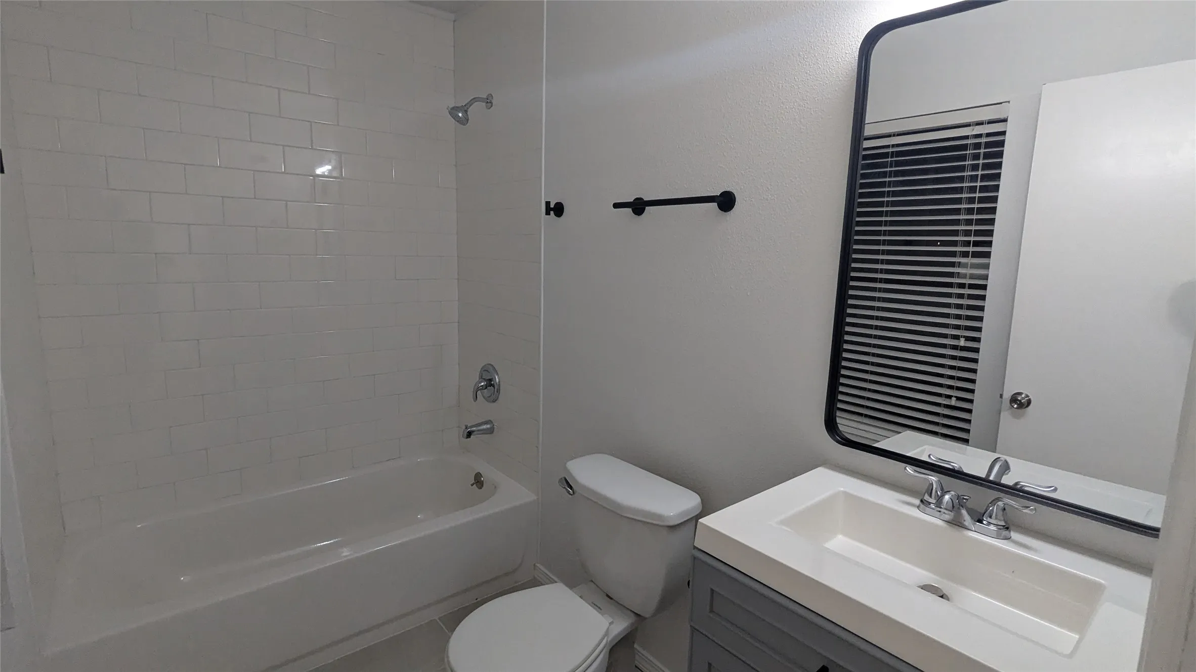 White subway tile shower surround with chrome fixtures