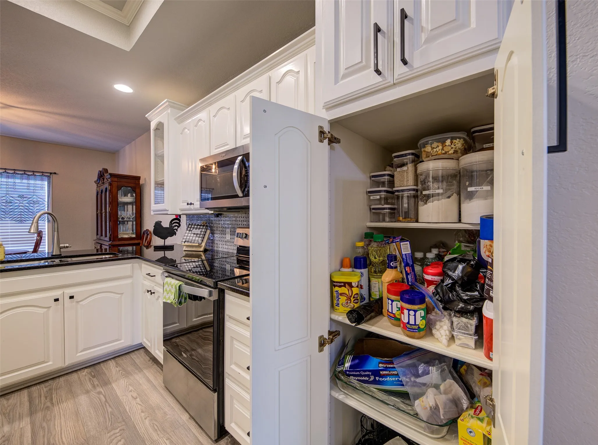 1st Pantry with wooden shelving and double doors