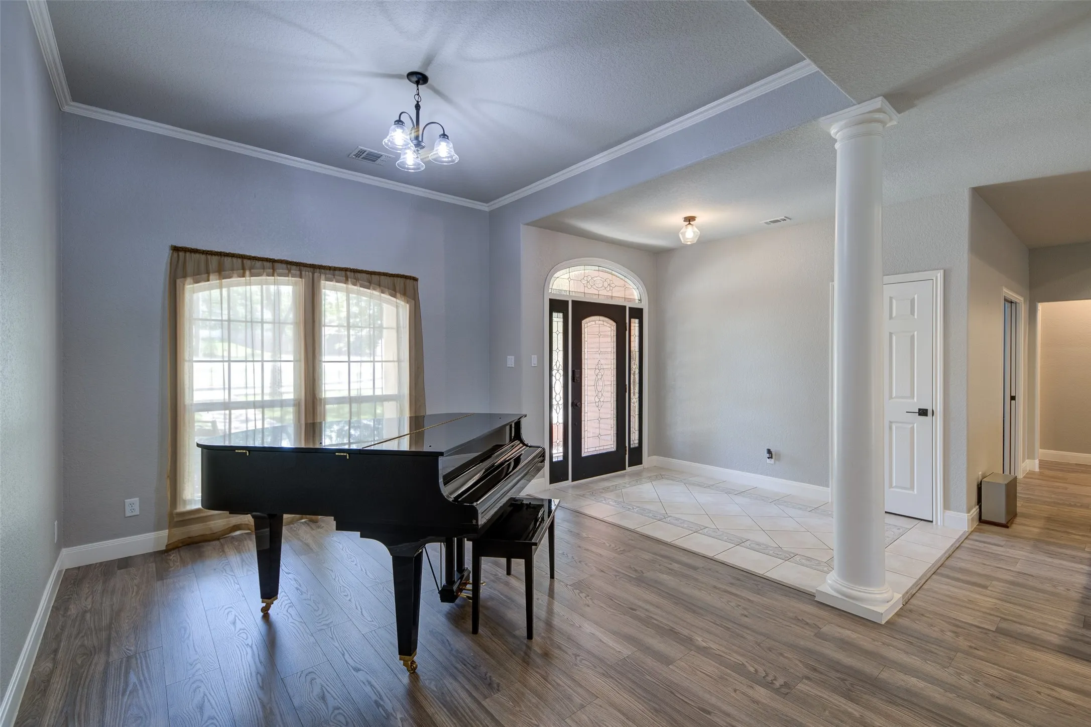 Wood-finish flooring, recessed lighting, and a modern ceiling fixture