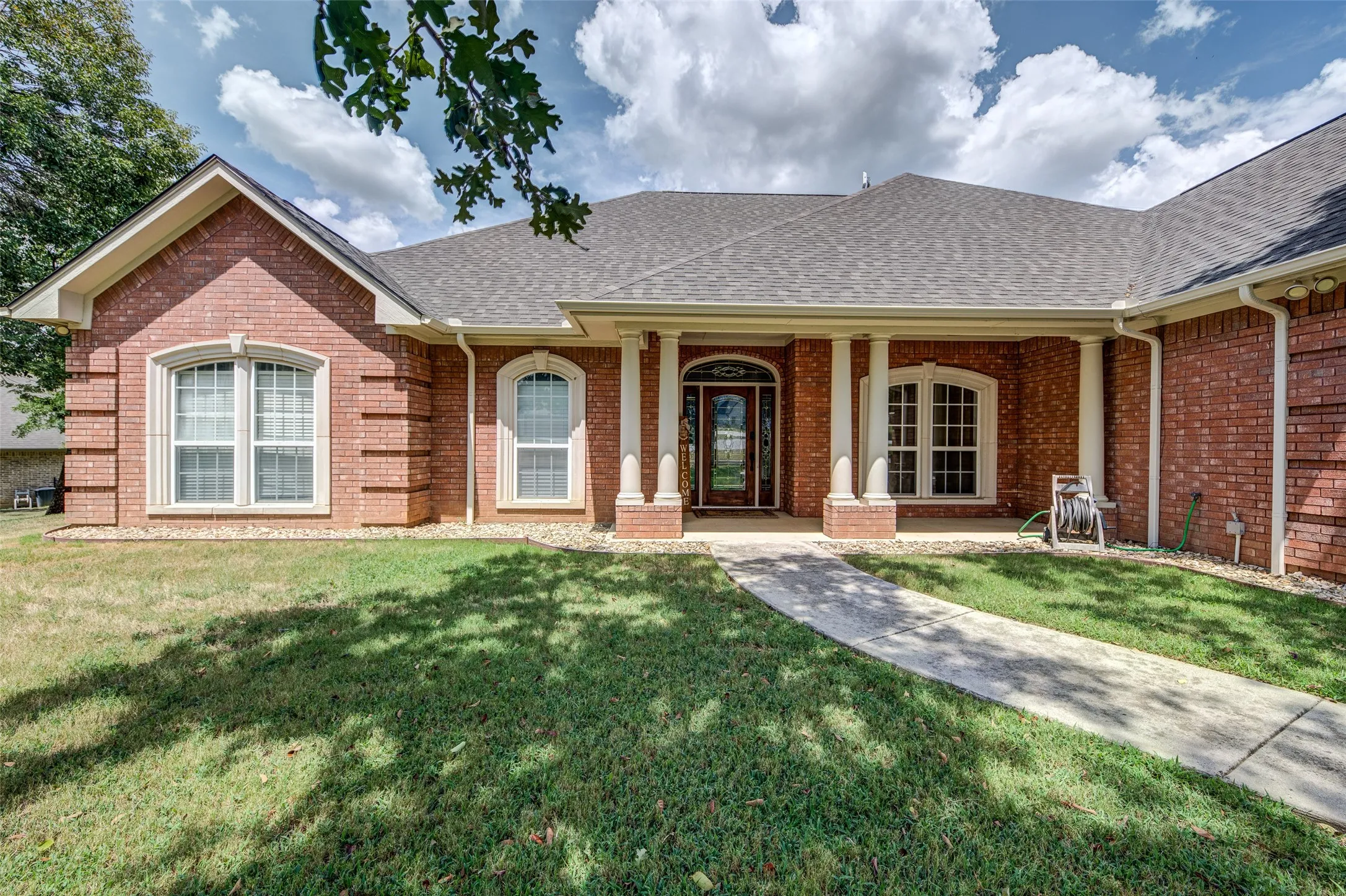 Brick exterior with a gabled roof and arched windows