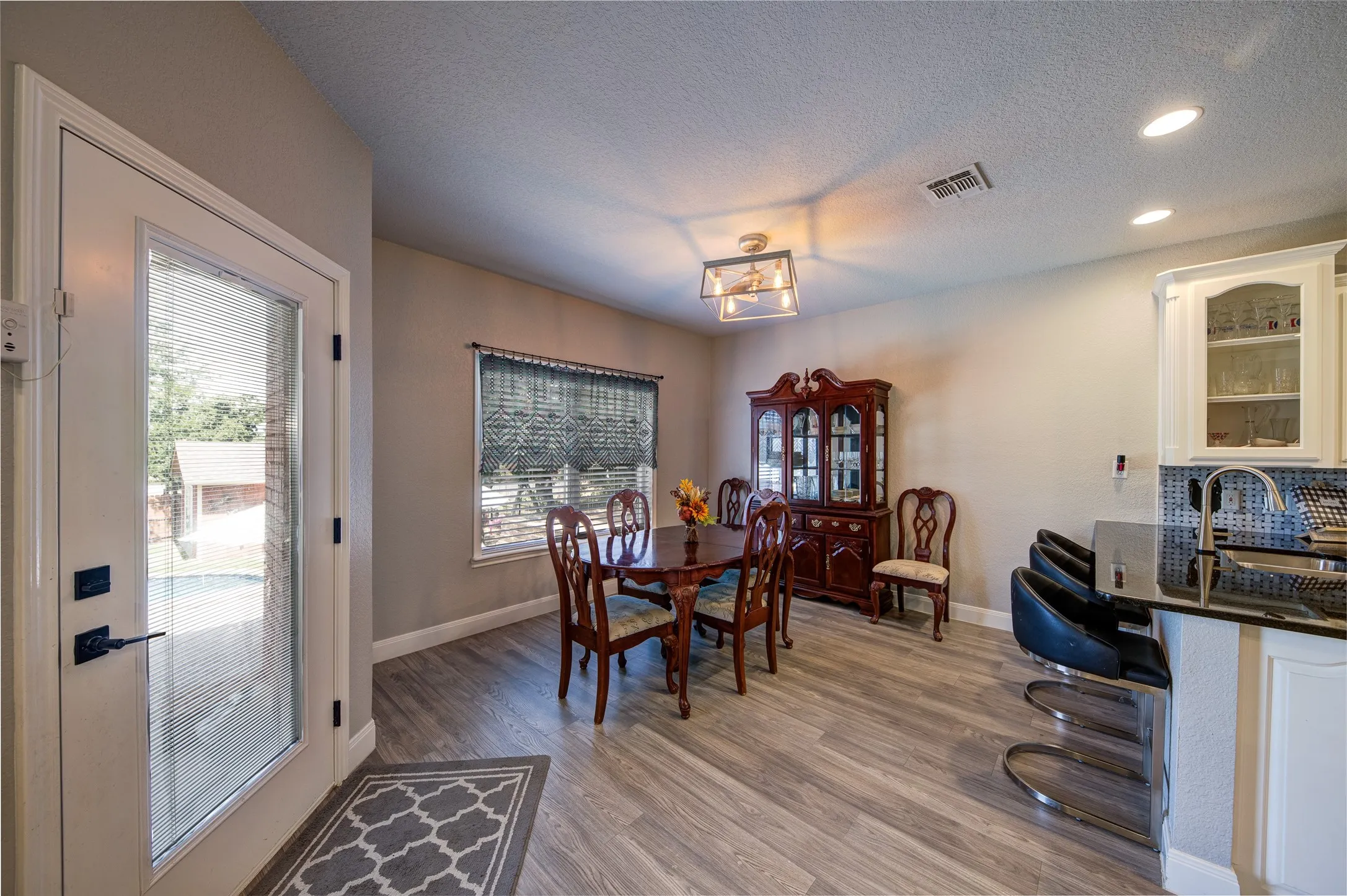 Wood-finish flooring, recessed lighting, and a modern ceiling fixture