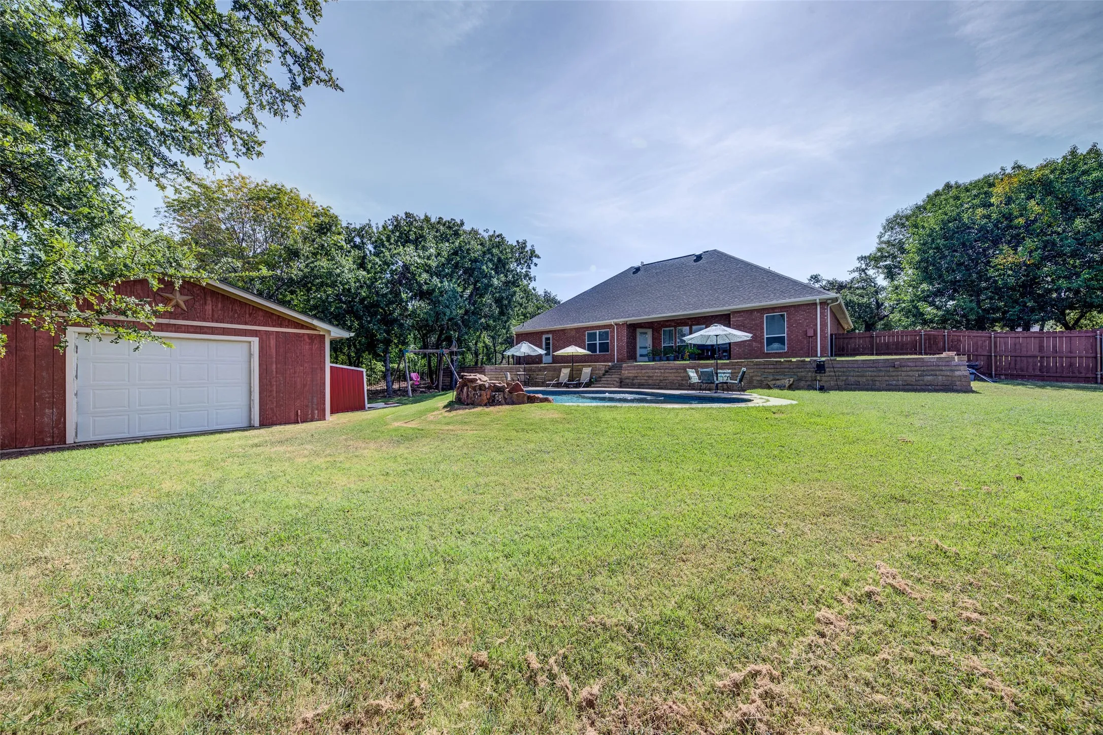 Large backyard with a storage shed