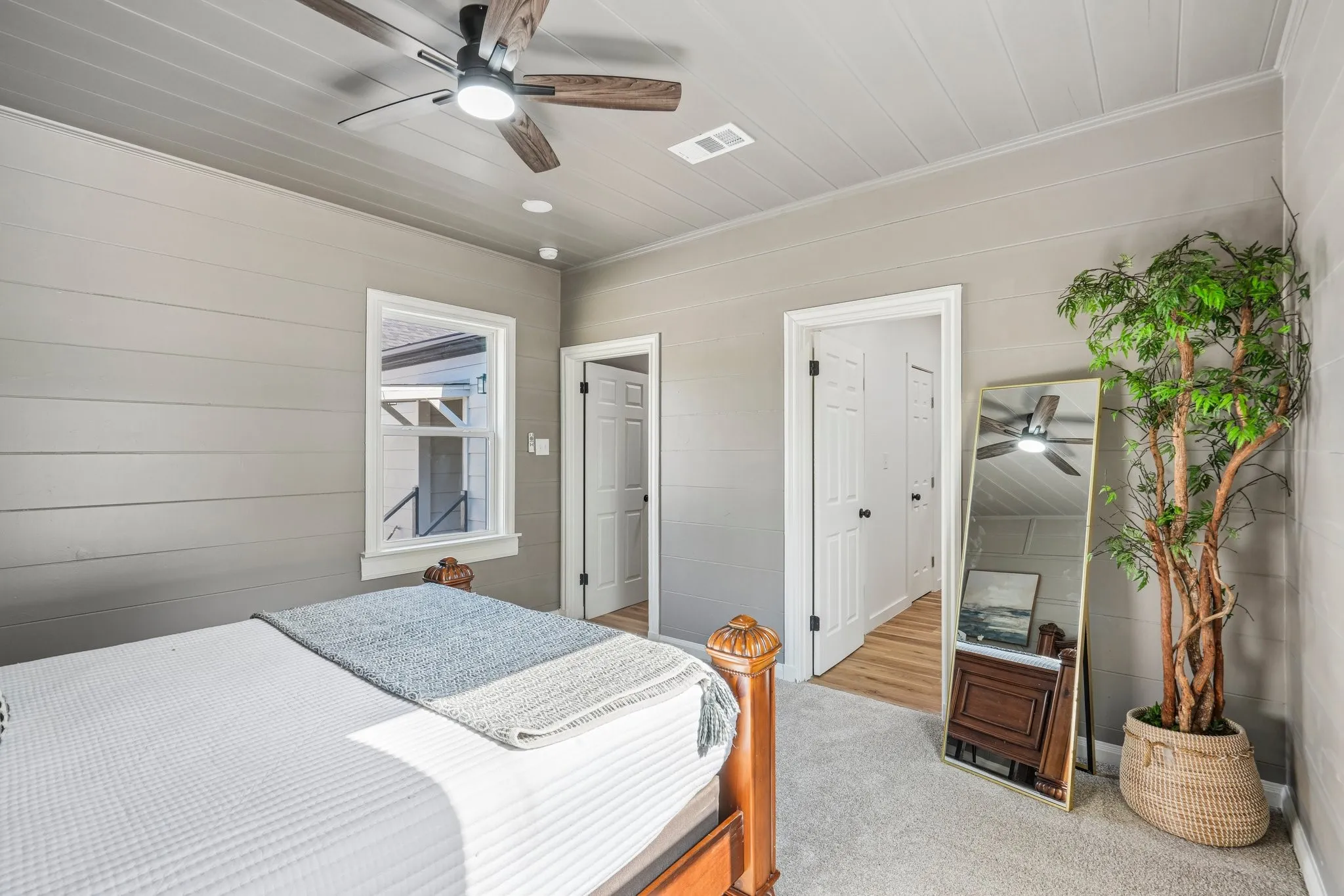 Shiplap wall paneling, planked ceiling, wood-finish ceiling fan, recessed lighting, and light-toned carpeting