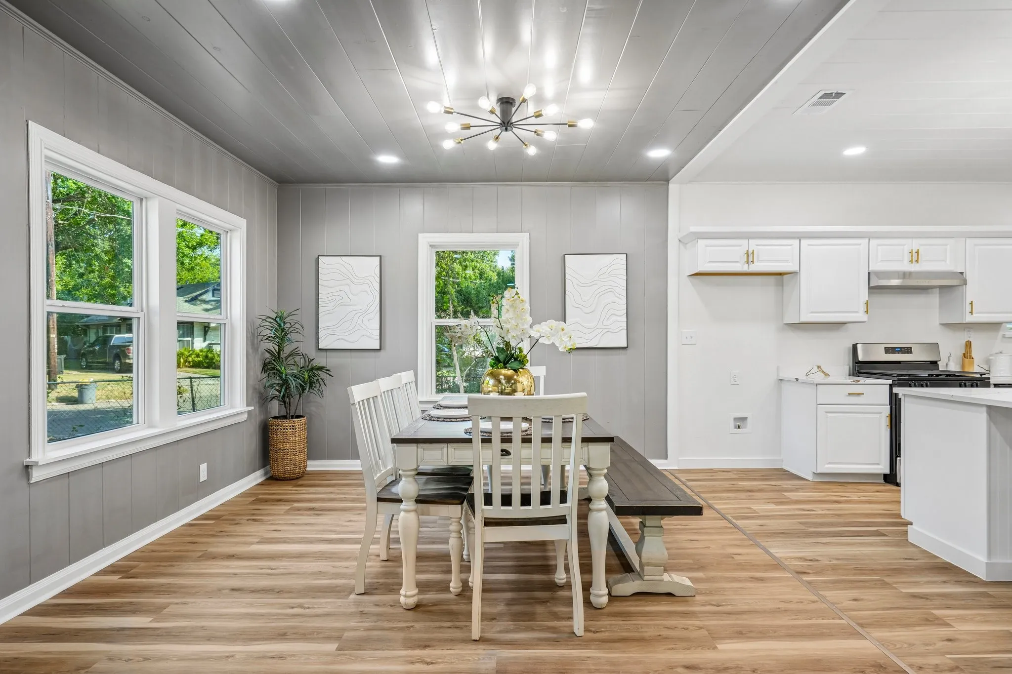 Wood-finish flooring throughout, with a contemporary sputnik chandelier and recessed lighting