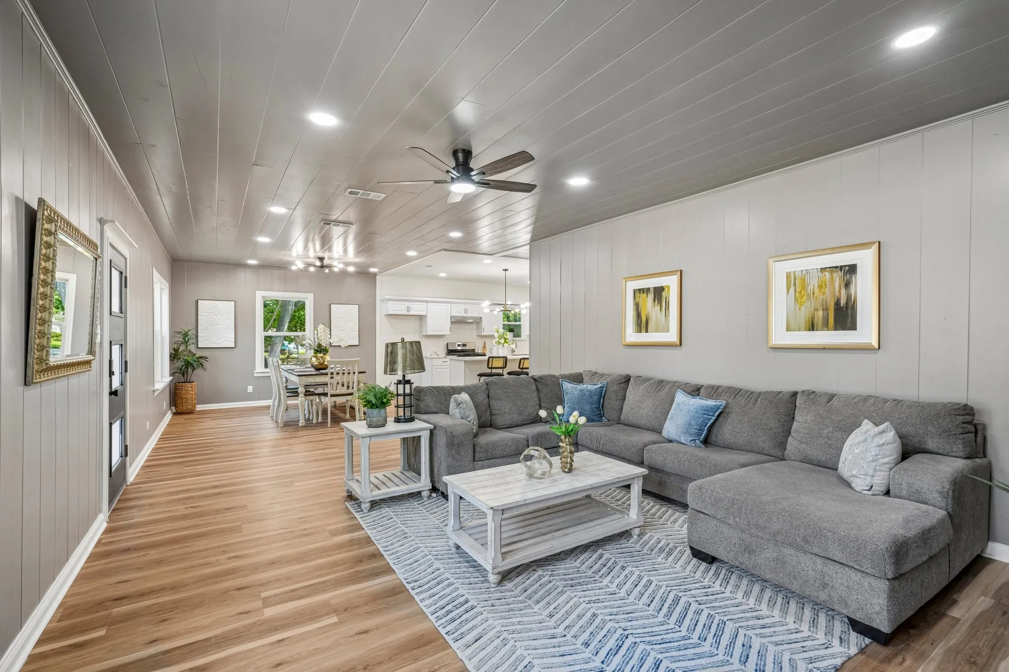 Open-concept living space featuring wood-finish flooring, recessed lighting, and a ceiling fan