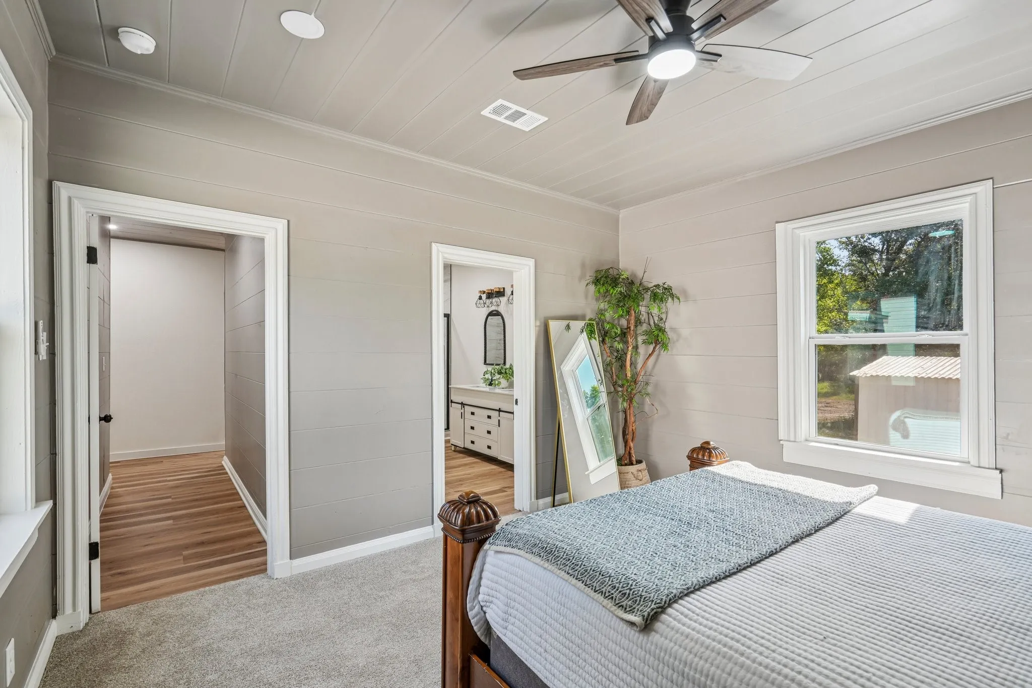 Recessed lighting, wood-finish ceiling, and a ceiling fan with integrated lighting