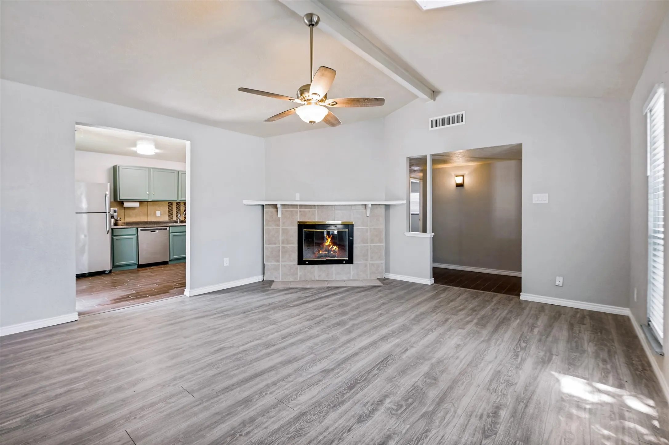 This picture depicts the access to the kitchen and the hallway to bedrooms and baths.