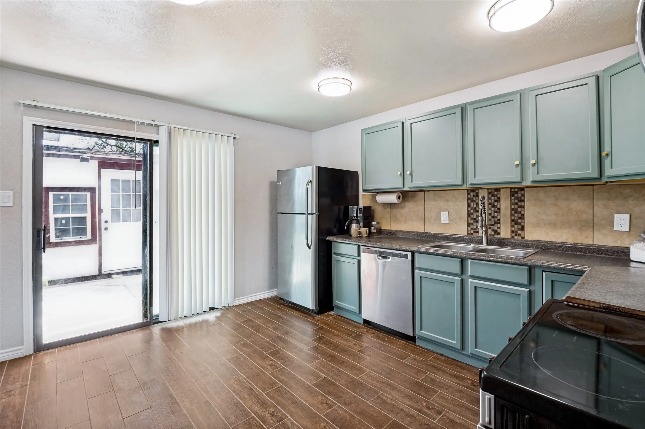 The kitchen provides easy access to the backyard to make outdoor dining a breeze,