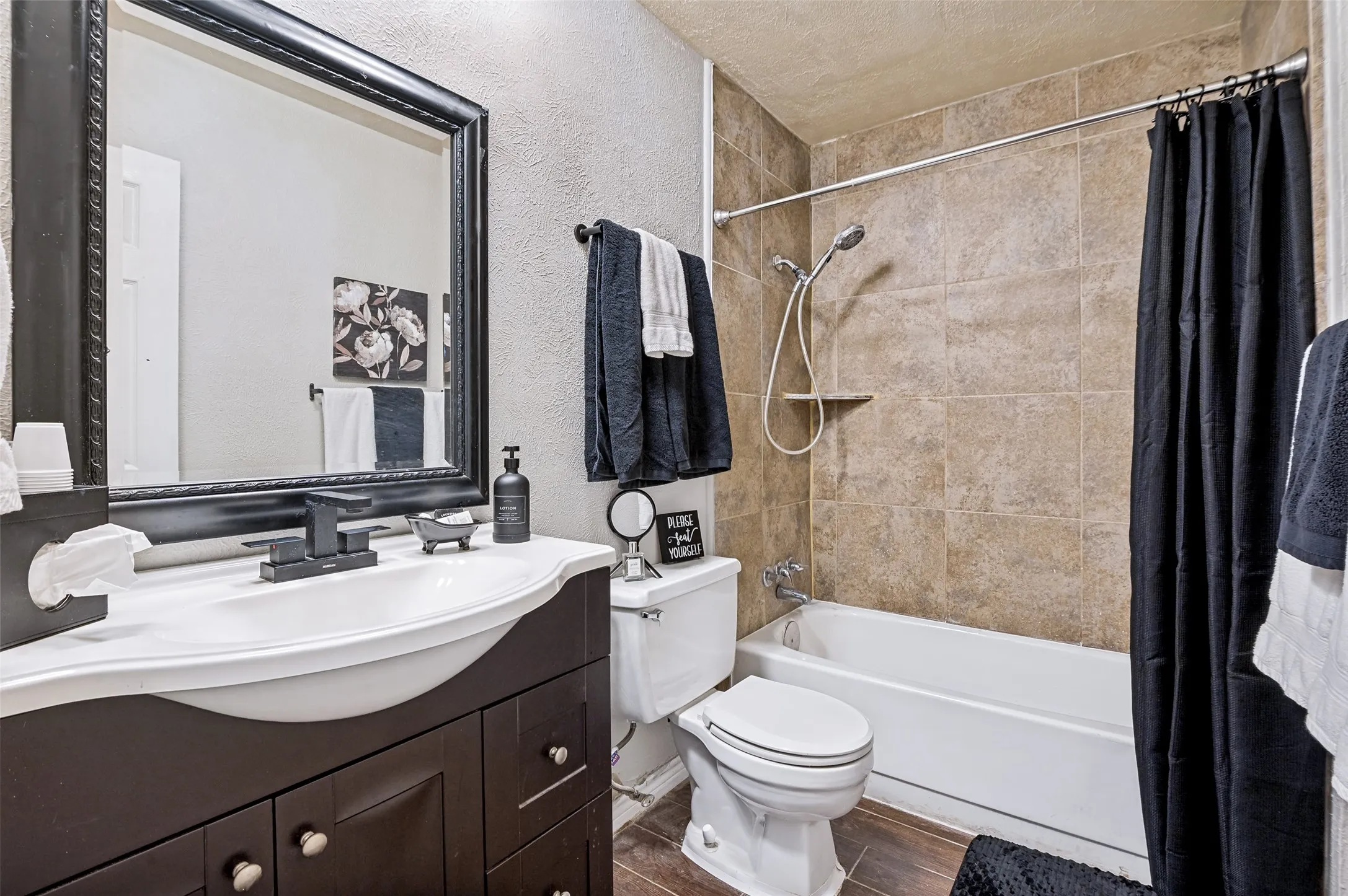 Enhancing this hall bathroom in which you get a tub/shower is an updated vanity.. perfect for quests and family.  The adjacent hallway has a coat closet and a linen closet which provide lots of additional storage.