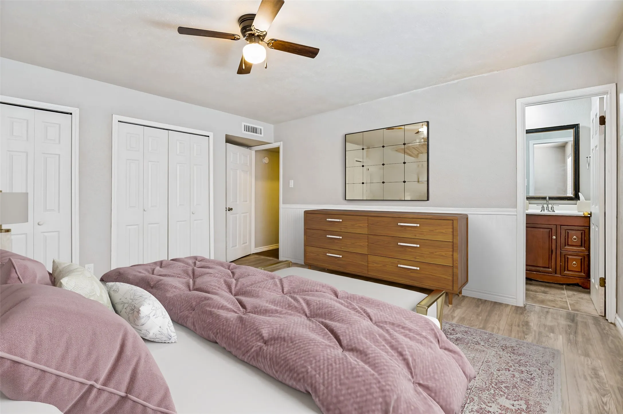 A wall of closets as well as the ensuite bathroom make this a real retreat