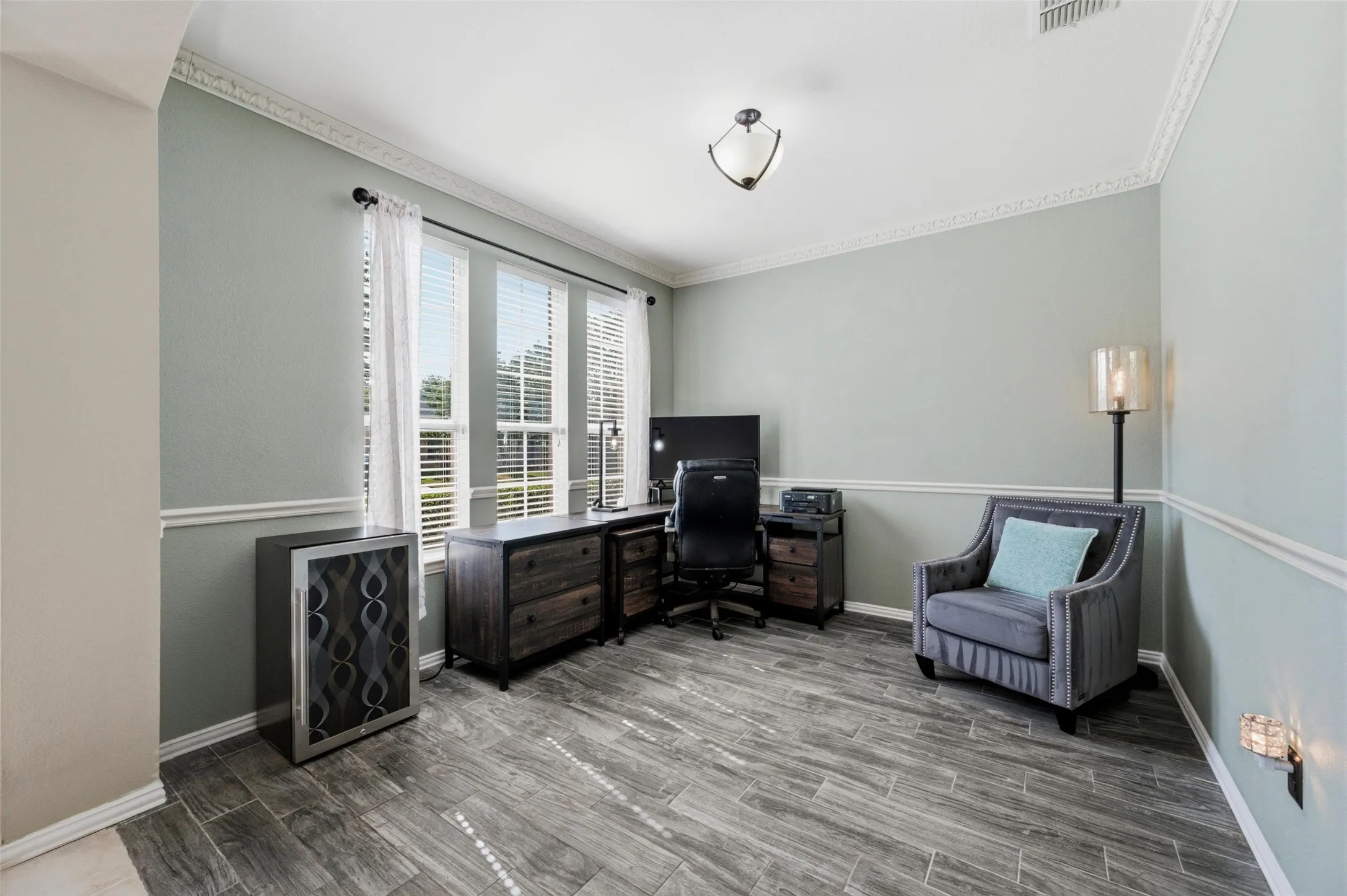 Wood-finish tile flooring complemented by light-toned wall paint