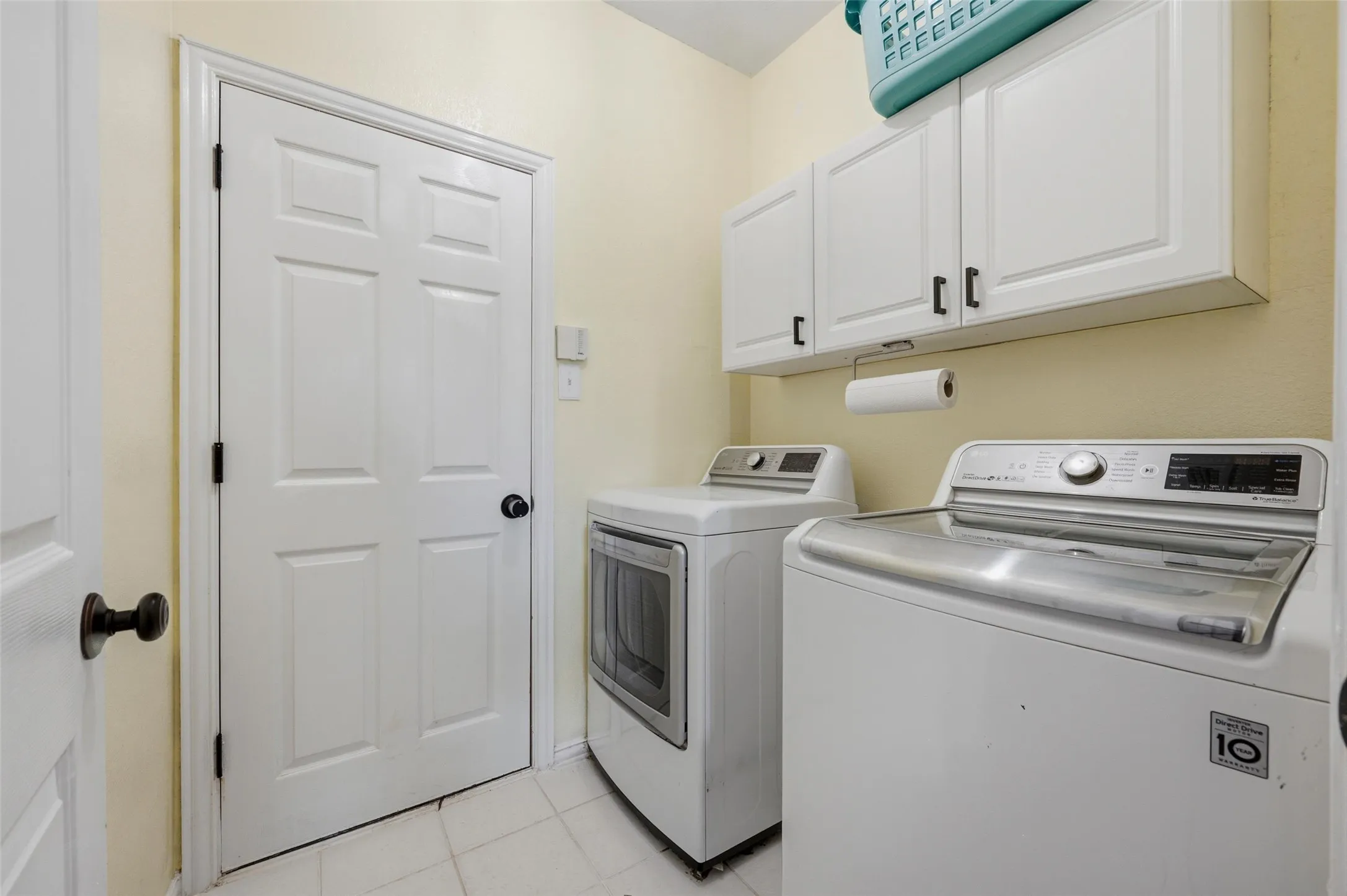 White paneled doors, wall-mounted cabinetry with dark hardware, and light-toned flooring
