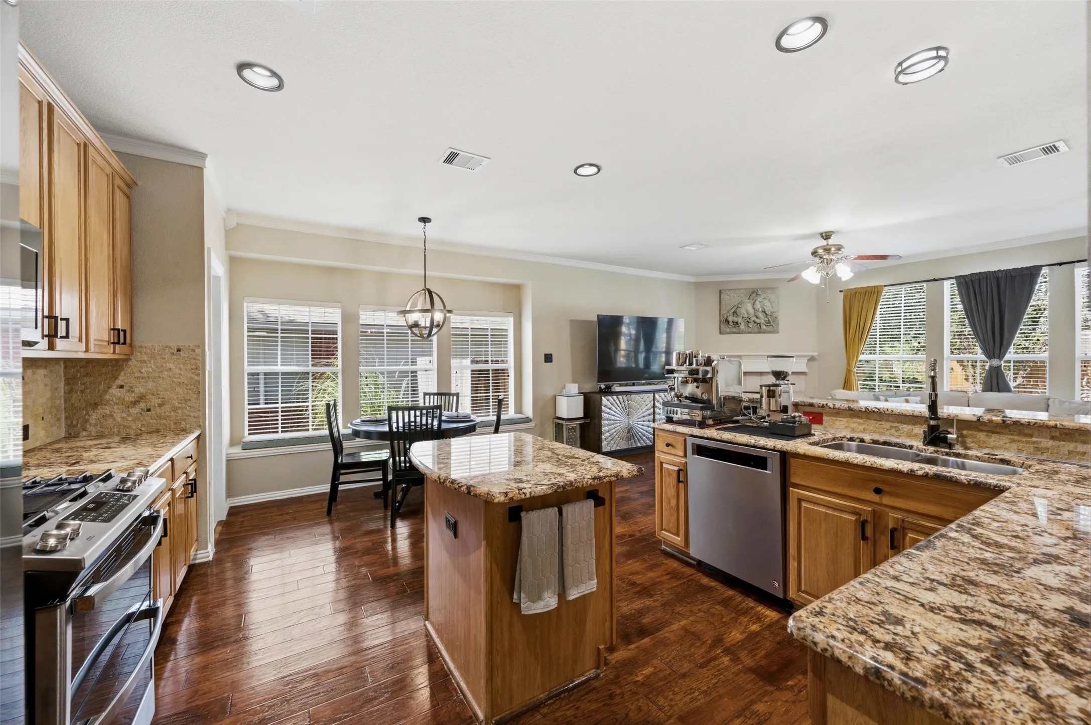 Wood-finish flooring throughout, complemented by light wood cabinetry and granite countertops