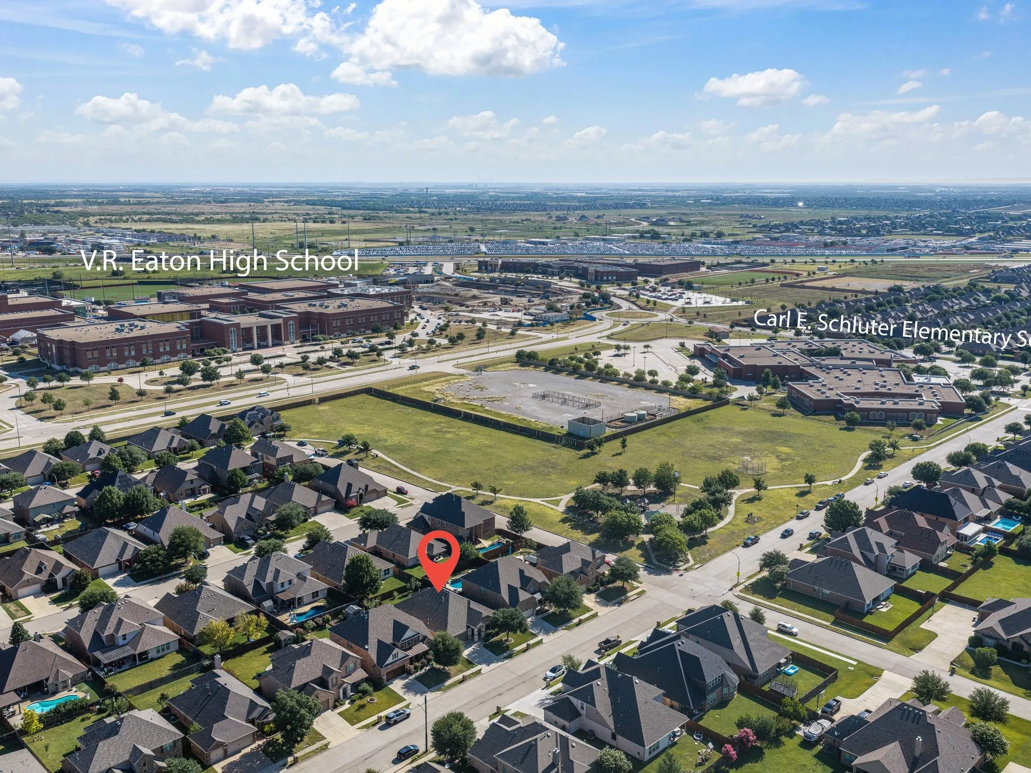 Aerial perspective showcasing residential properties within a developed neighborhood