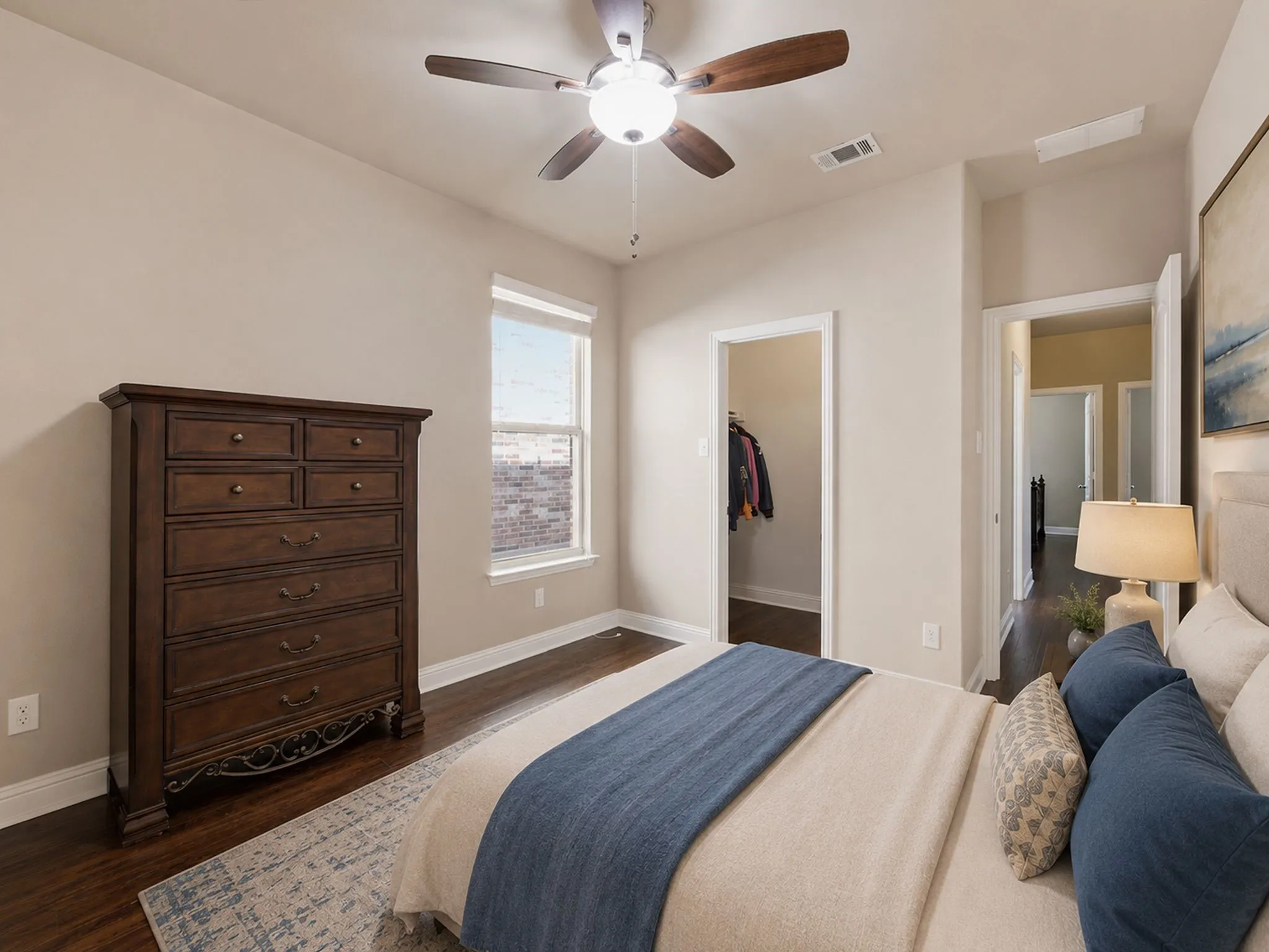 Wood-finish flooring, ceiling fan with integrated lighting, recessed window, and an open closet