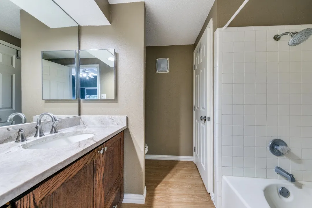 Master bath with stone counters and garden tub.