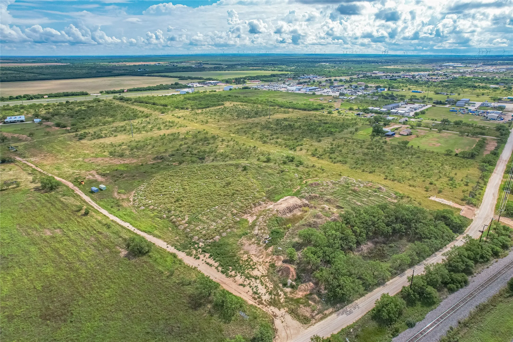 Expansive land parcel featuring natural terrain and distant structures