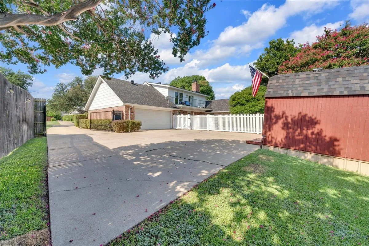 Gated driveway to 2-car garage & barn.