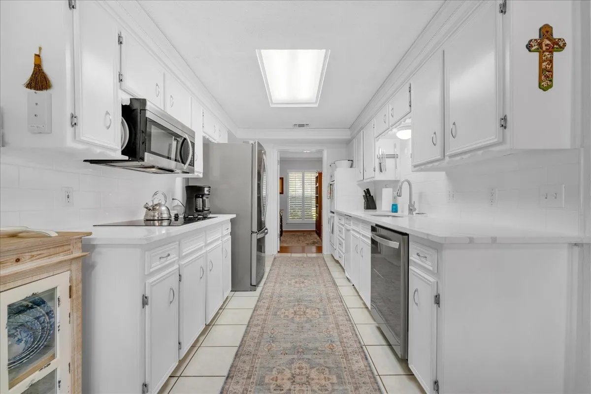 White kitchen with new quartz countertops.