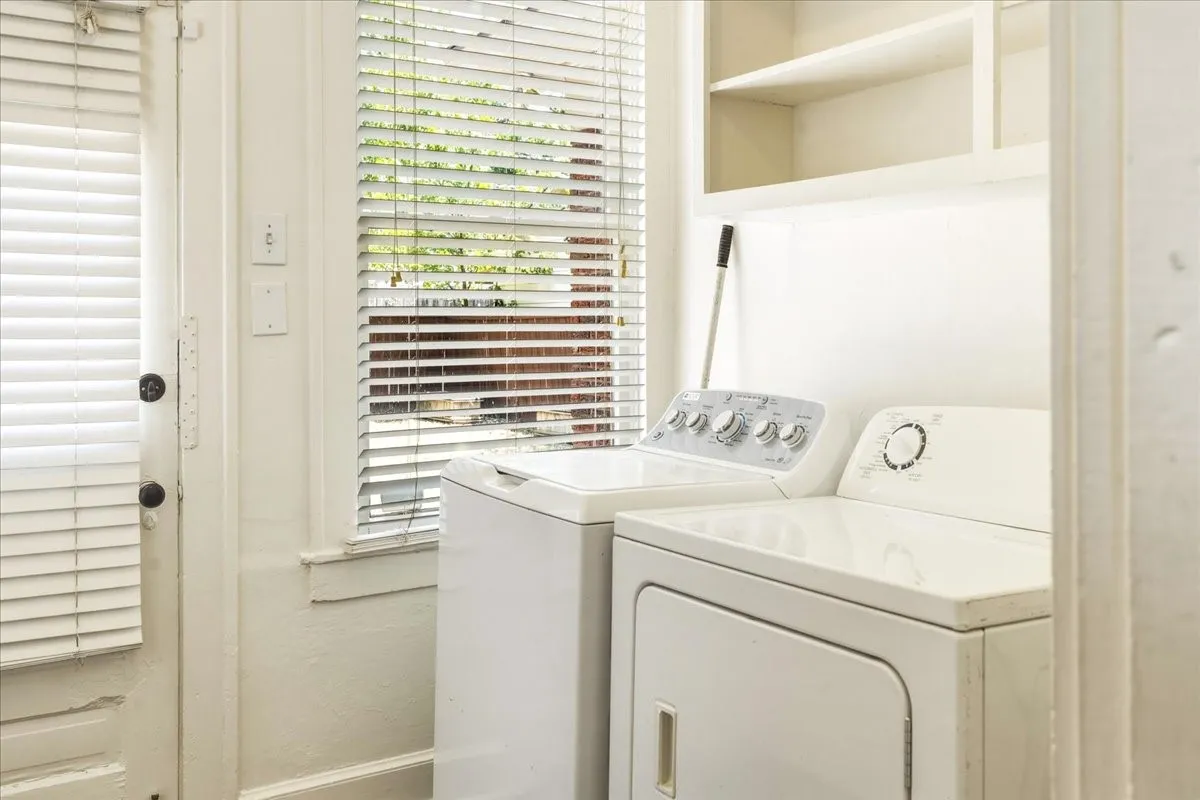 Utility room with cabinets and mud room space on other wall.